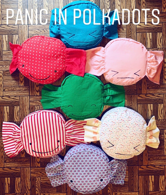 "Panic in Polkadots" words over an aerial photo of a group of colorful candy photos
