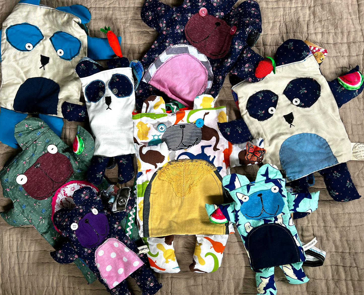 Bear tote bags assorted in an array on a neutral quilt background
