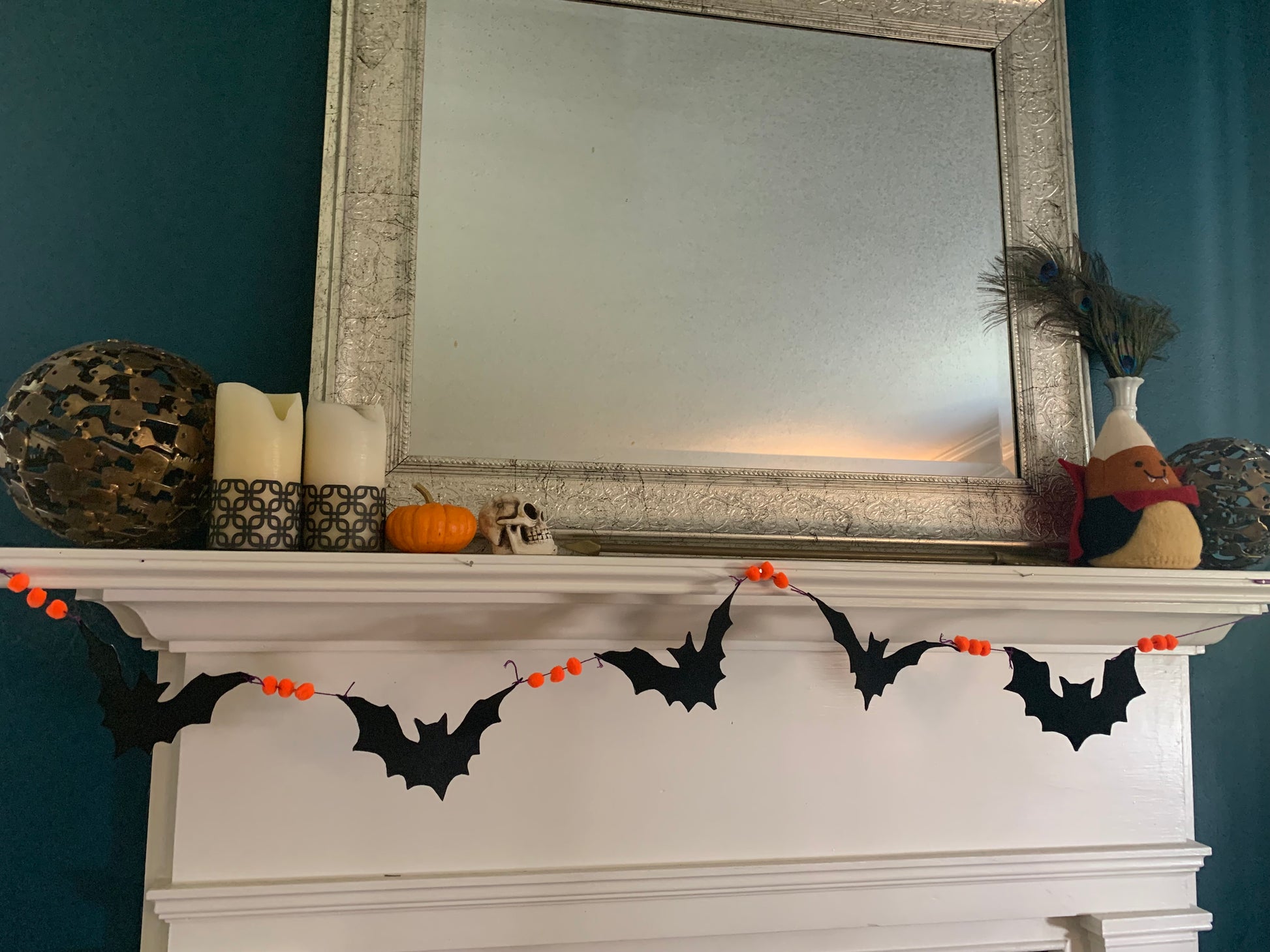 a front view of mantle with bat garland.