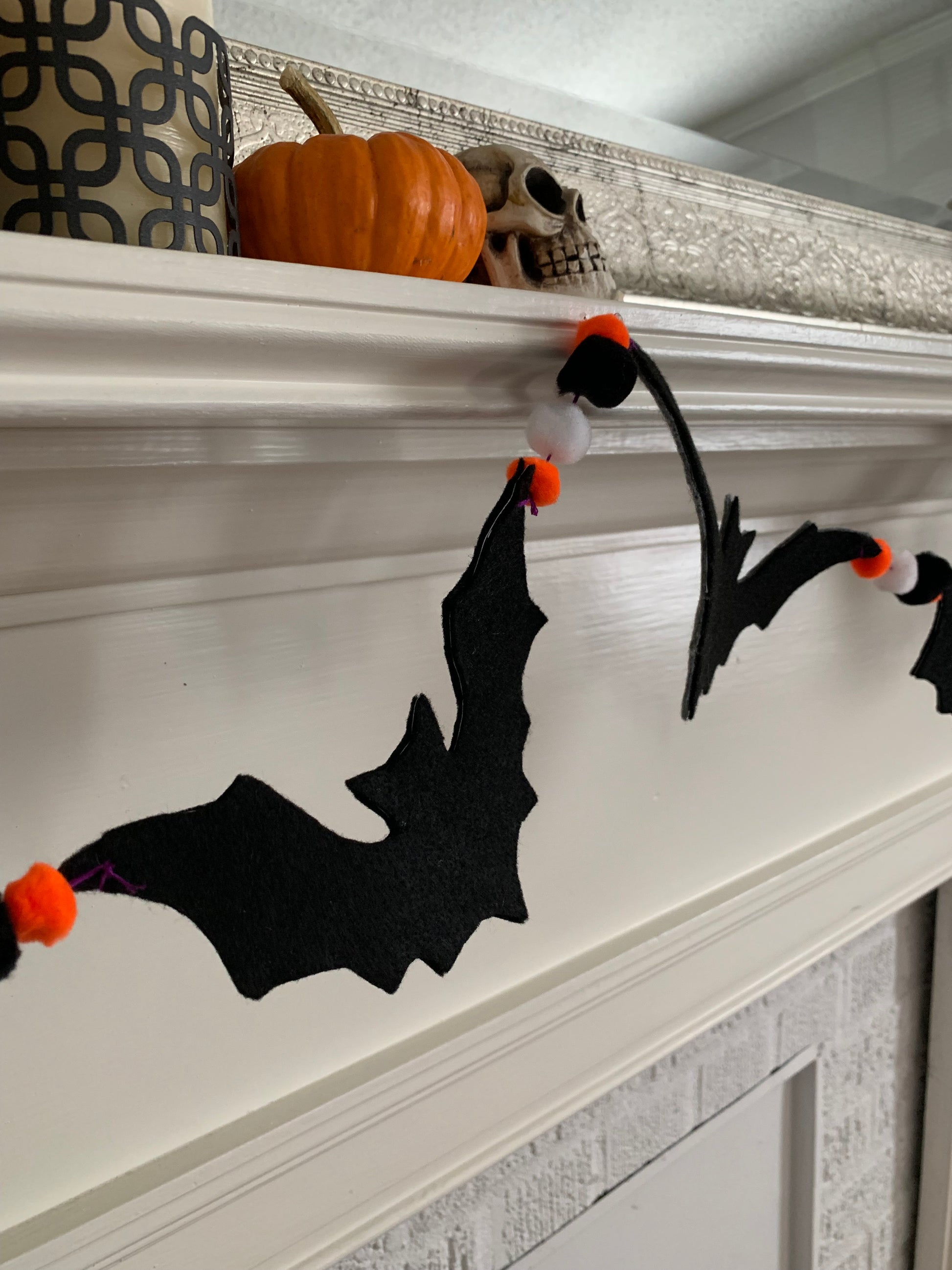 a closeup of the black felt bat garland, as it is strung on the mantle.