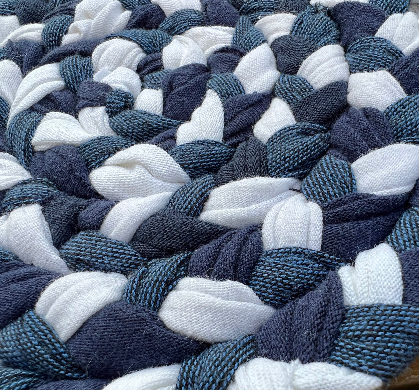 Close up, side view, showing detail in hand braided trivet