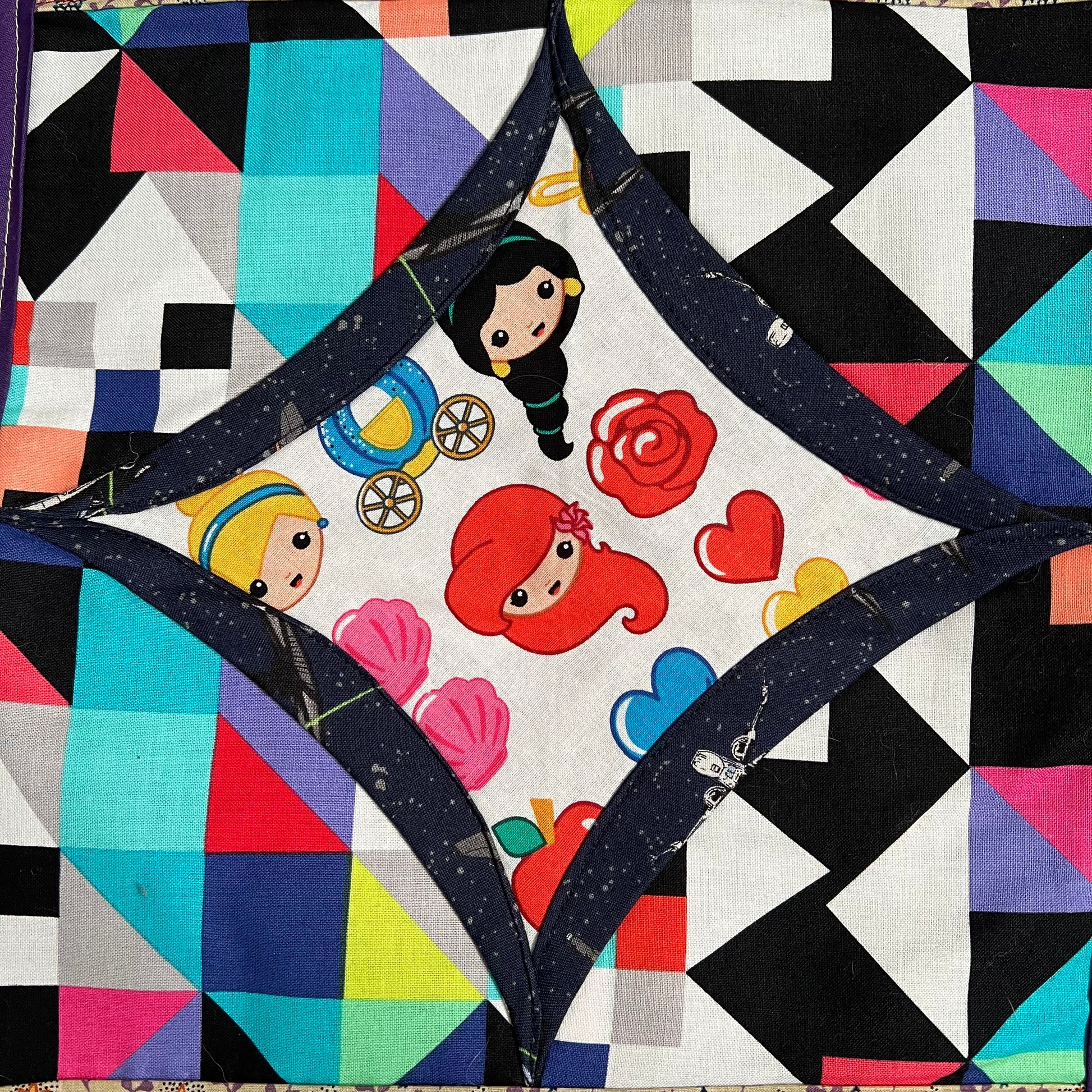 cartoon disney princesses fabric square, surrounded by starry navy, then colorful geometric fabric