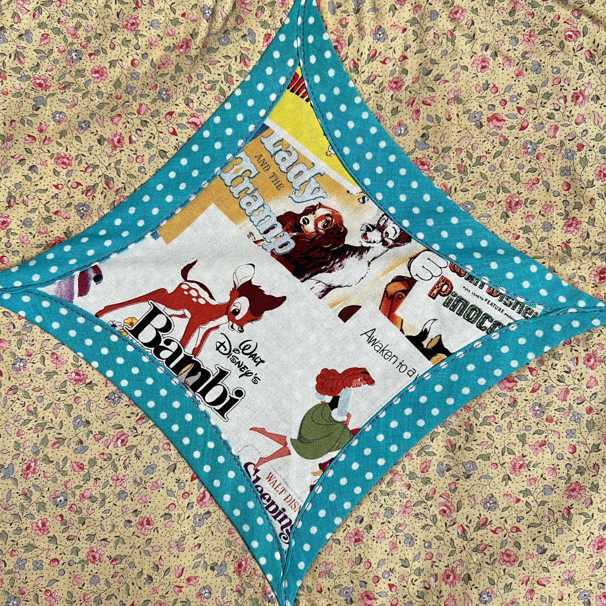 disney bambi fabric square, surrounded by blue polkadots, then light floral fabric
