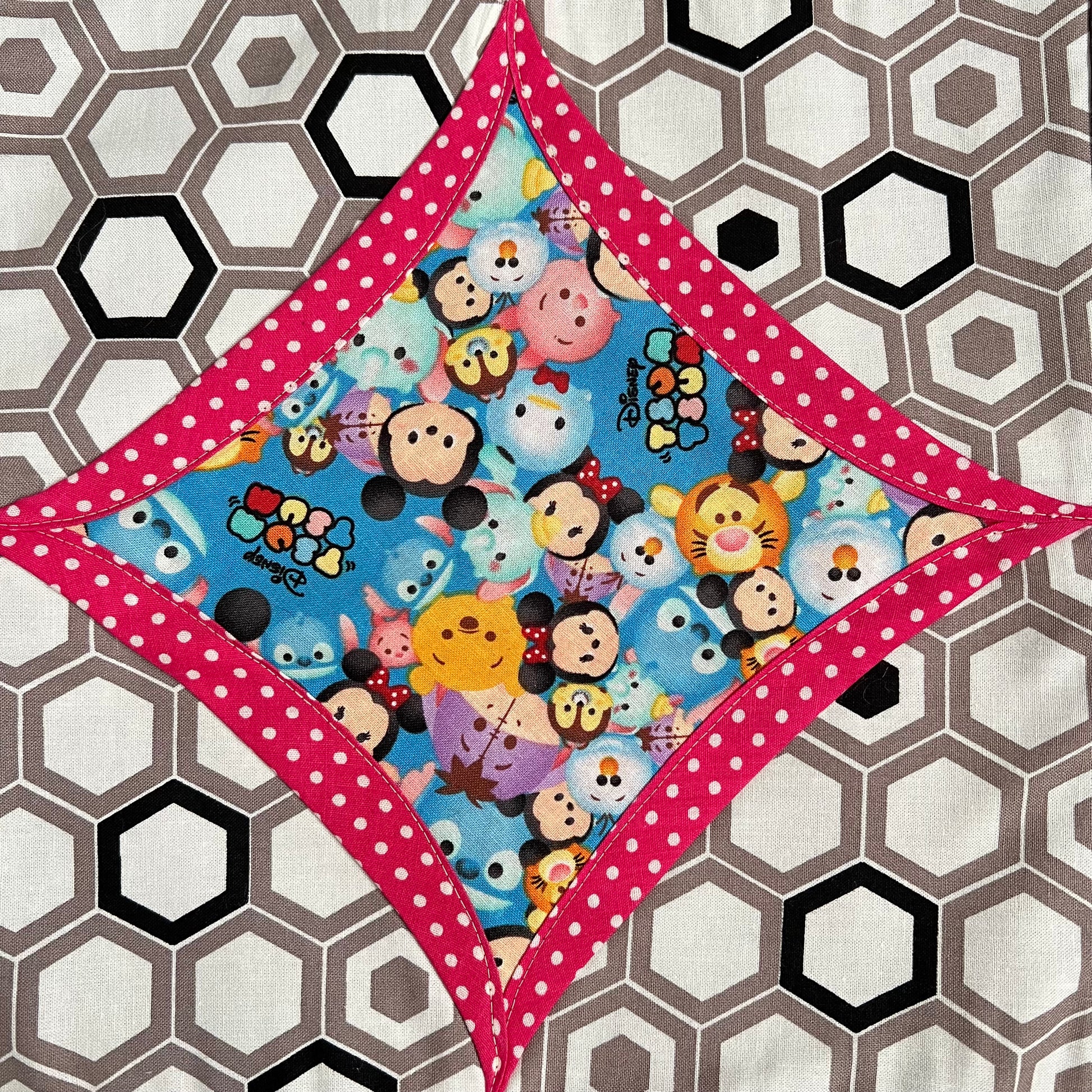 tsum tsum fabric square, surrounded by pink polkadots, and hexagons