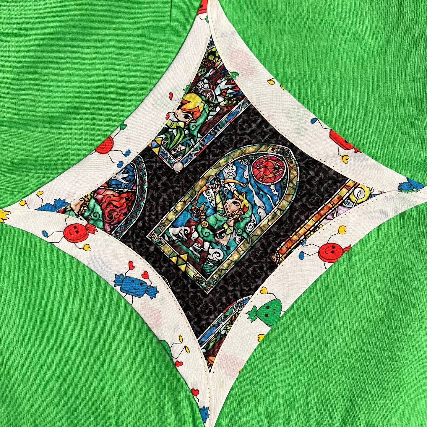 zelda fabric square, surrounded by retro candy, then neon green fabric