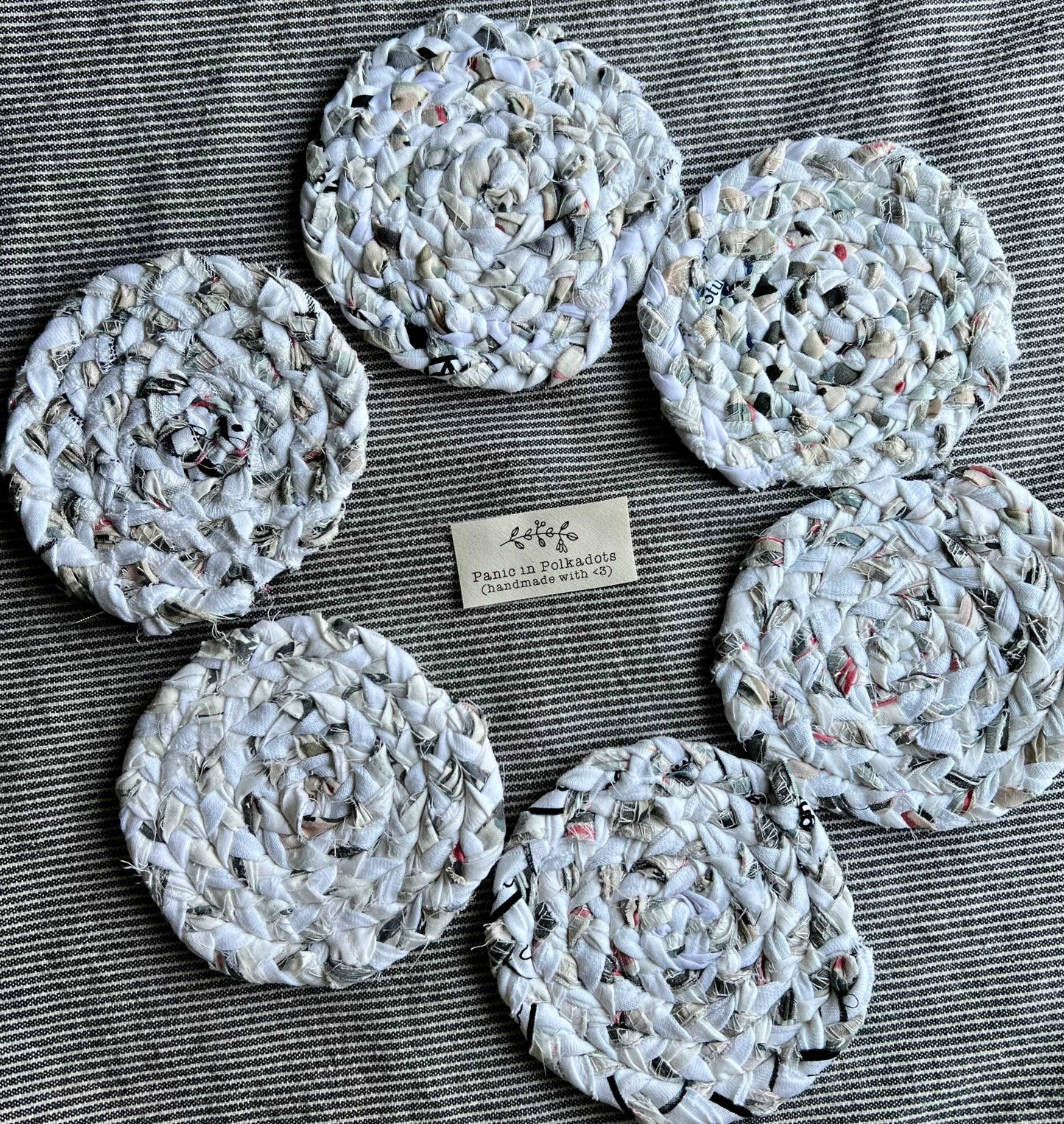 Mini rug coaster set of six, in a circle formation, with a Panic tag in the middle, aerial view