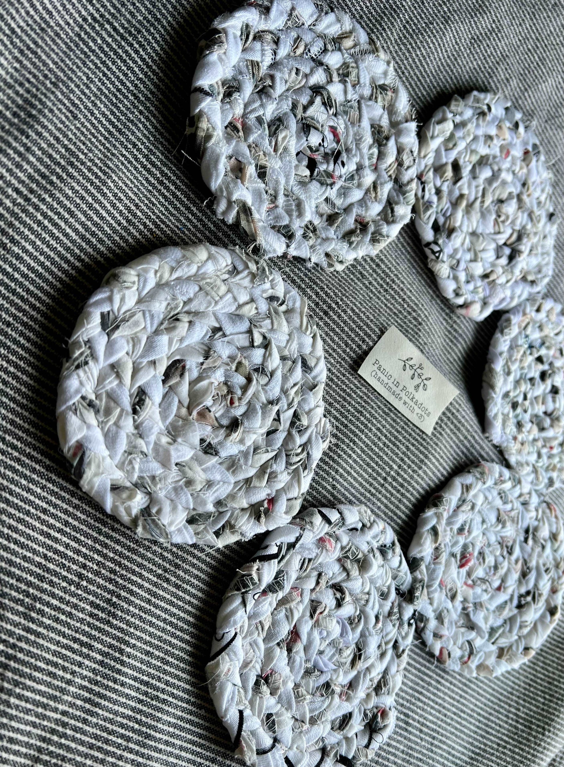 Mini rug coaster set of six, in a circle formation, with a Panic tag in the middle, side view