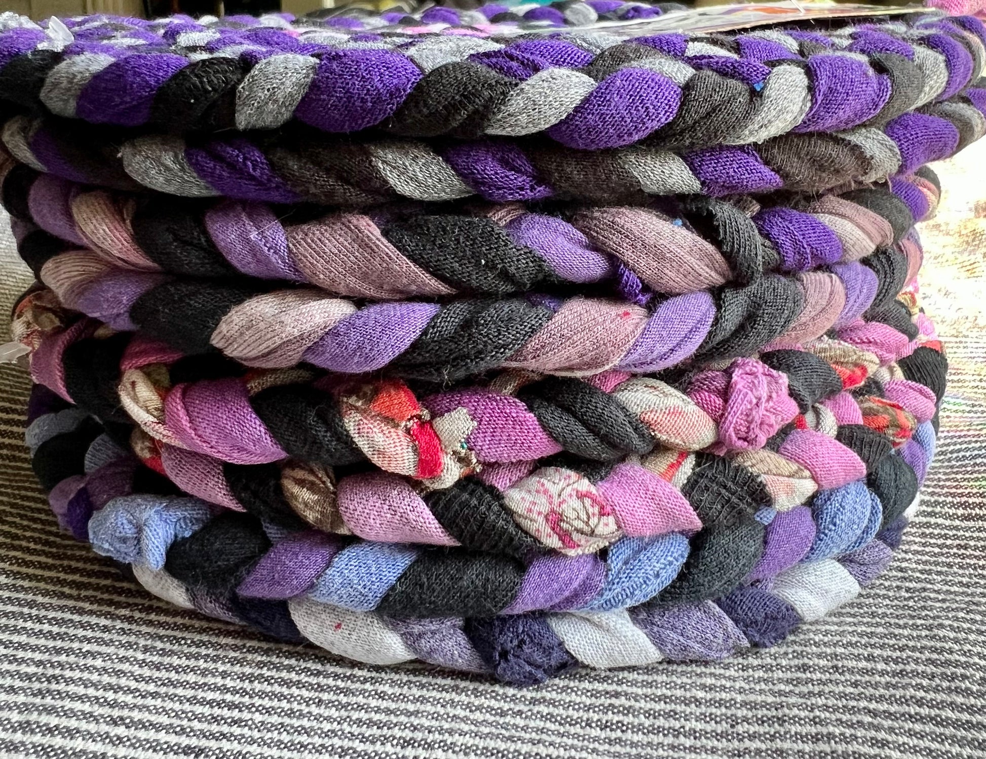 A stack of purple and pink trivets, side view.