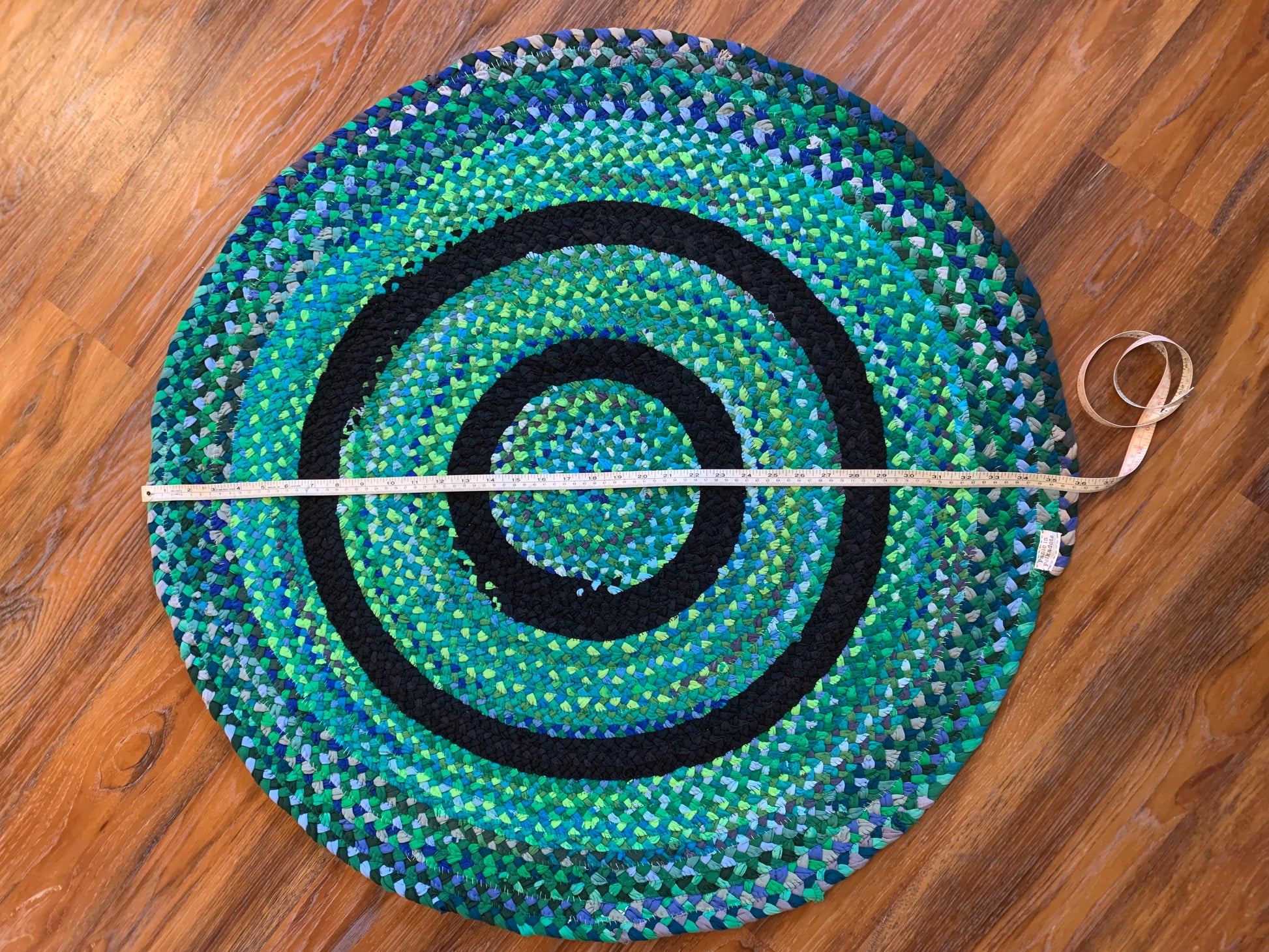 aerial view of the entire rug, with measuring tape across the diameter