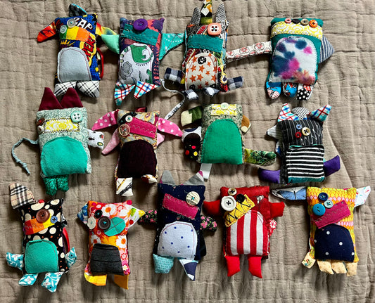 A group of mini monster keychain ornaments, in a group, aerial view flat lay.