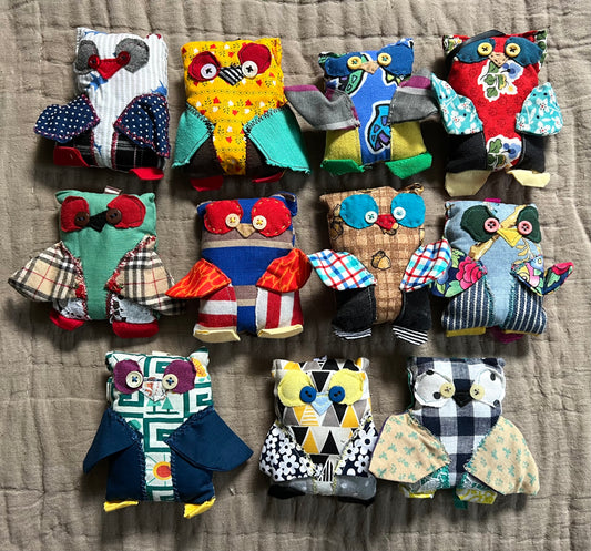 A group of mini owl keychain ornaments, in a group, aerial view flat lay.