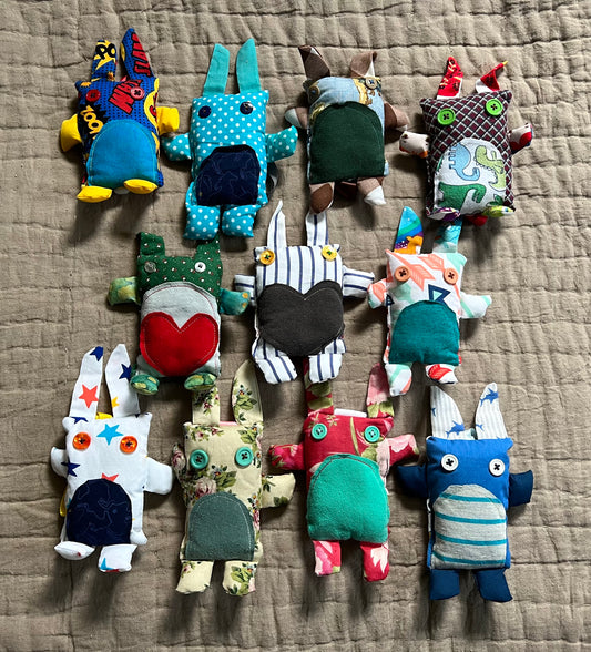 A group of mini bunny rabbit keychain ornaments, in a group, aerial view flat lay.