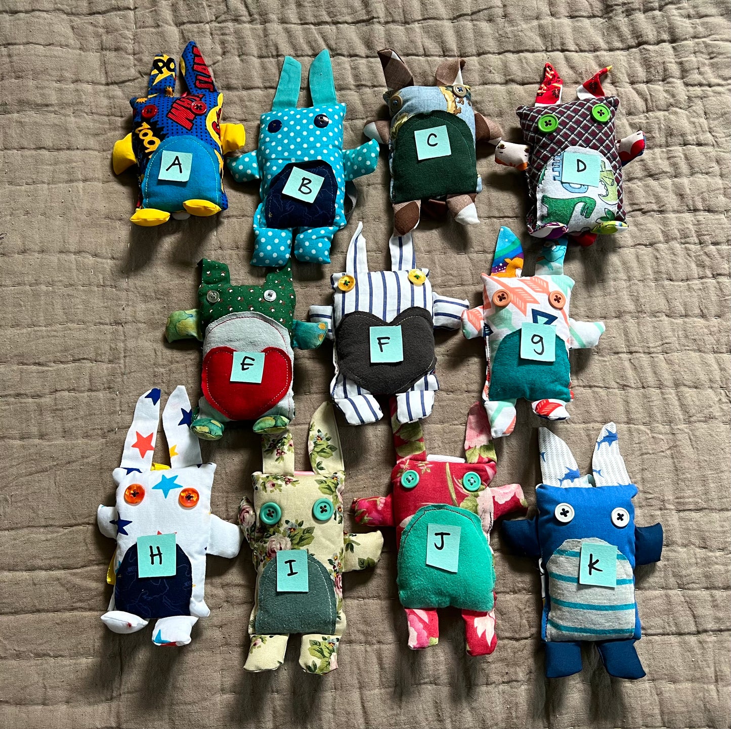 front view of mini bunny keychain ornaments, with letters on top for easy selection.