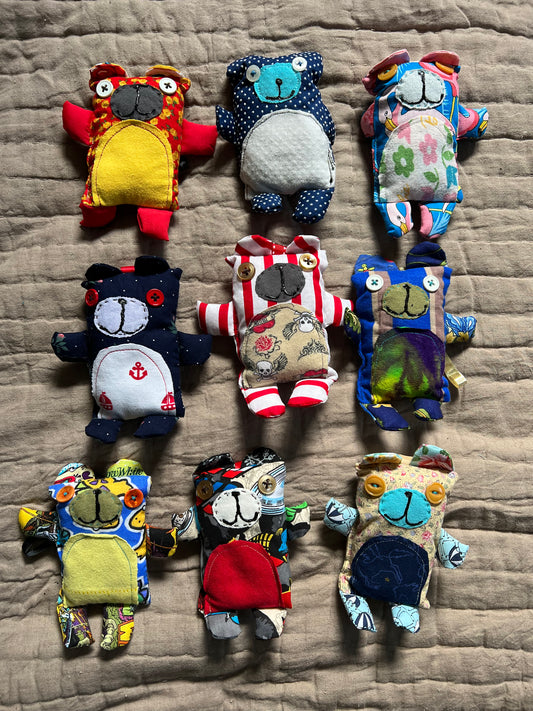 A group of mini bear keychain ornaments, in a group, aerial view flat lay.