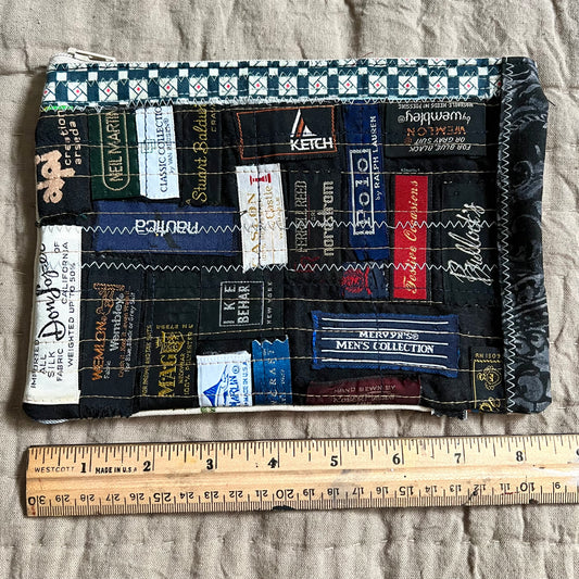 front view of necktie label zipper pouch, with a ruler underneath which indicates 8.5 inches