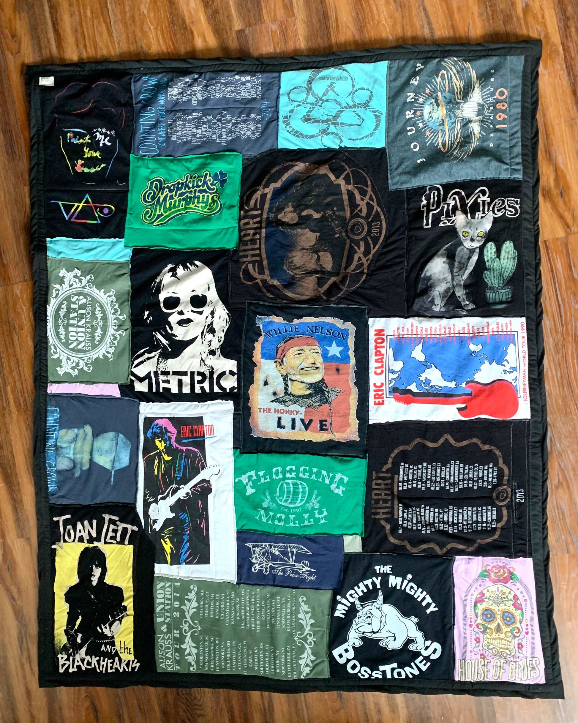 A collage tshirt custom quilt, with various bands: Metric, Dropkick Murphys, Joan Jett, Pixies, Journey, Might Might Bosstones, Heart, Flogging Molly