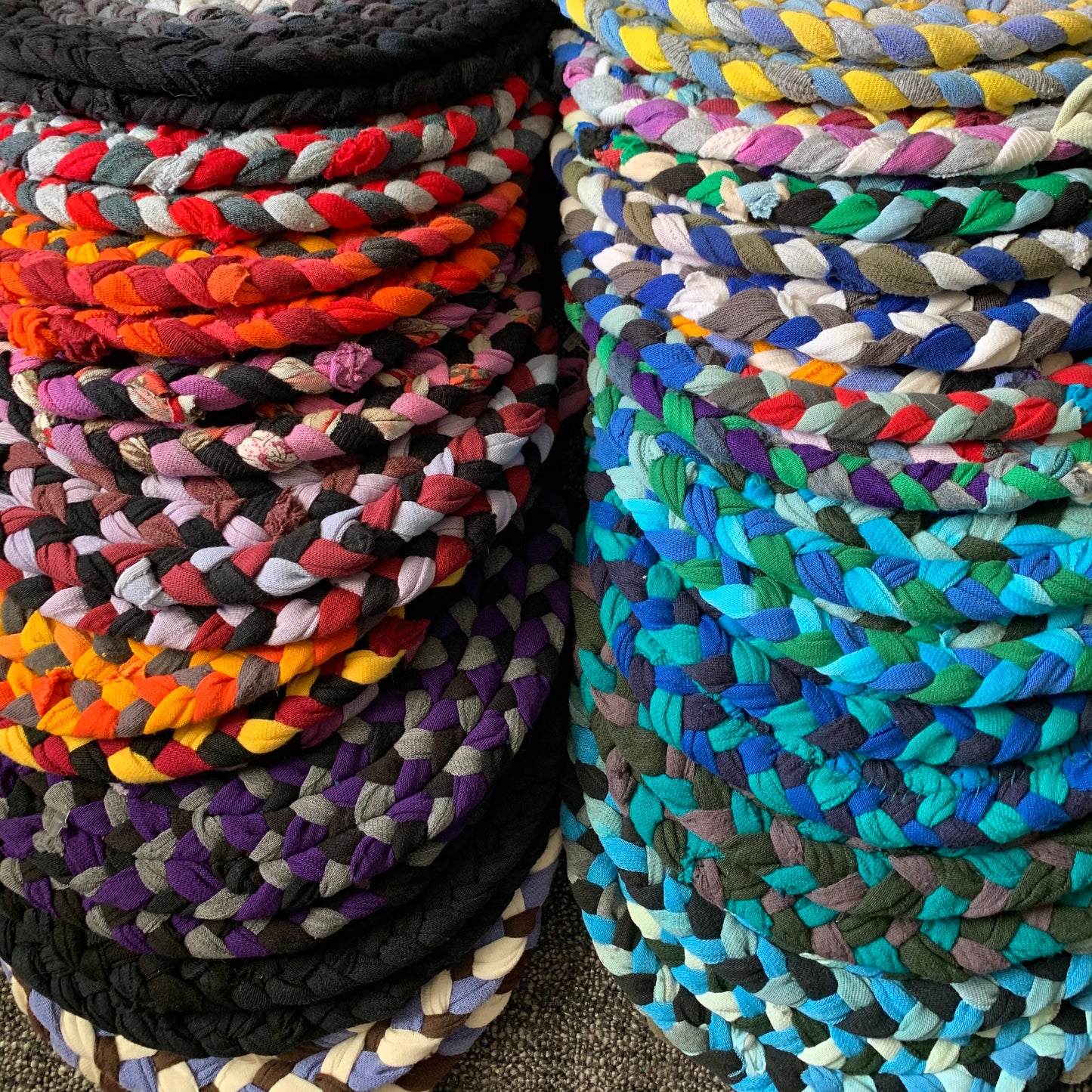 All of the trivet potholders, in a spectrum of colors, lay flat in two rows.