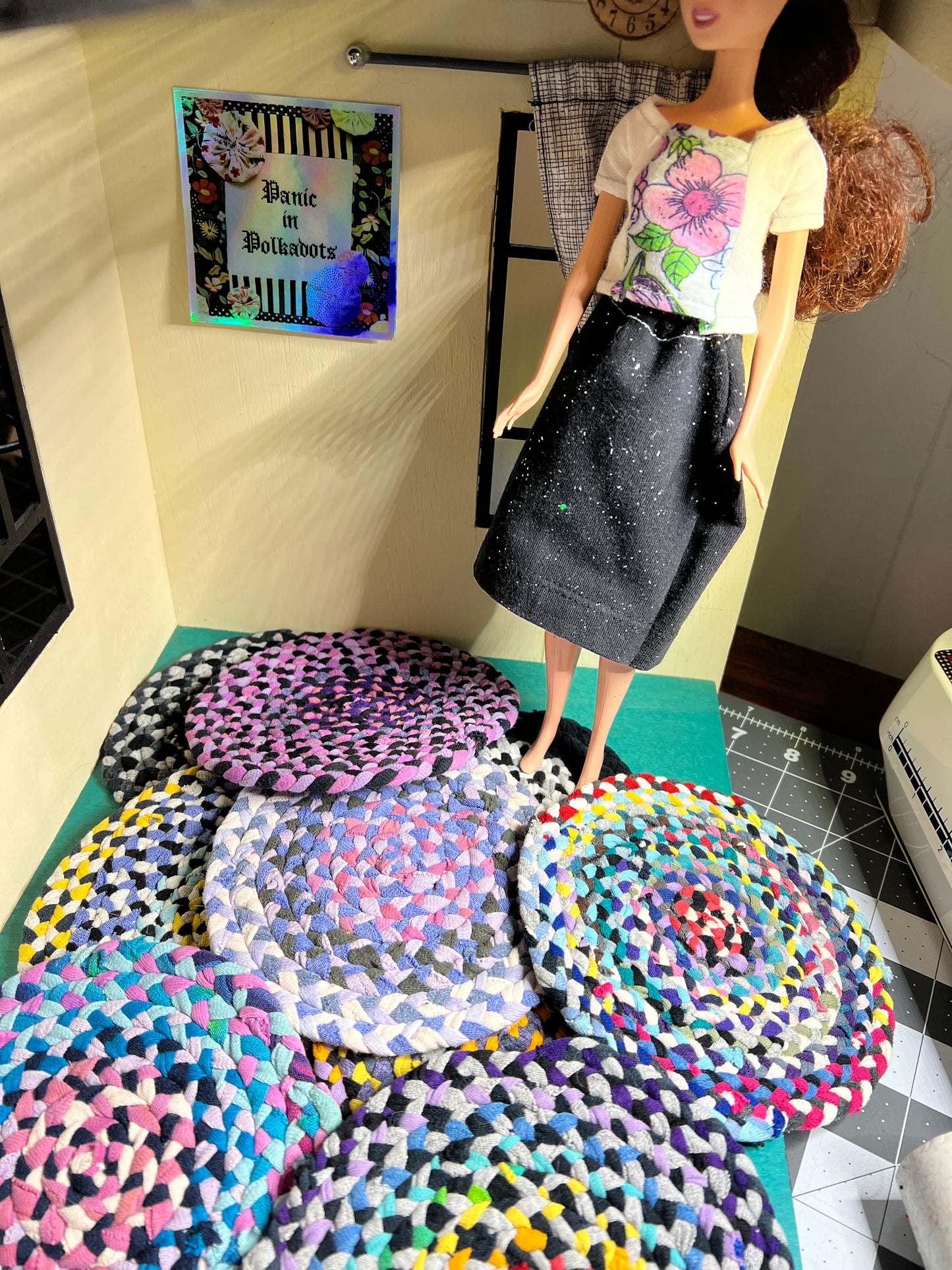 Barbie stands on top of a group of 5" miniature handbraided and handsewn rugs