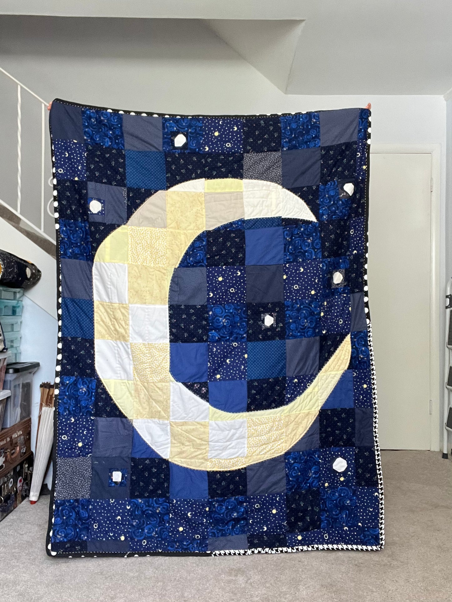 moon quilt held inside, to show variations in lighting