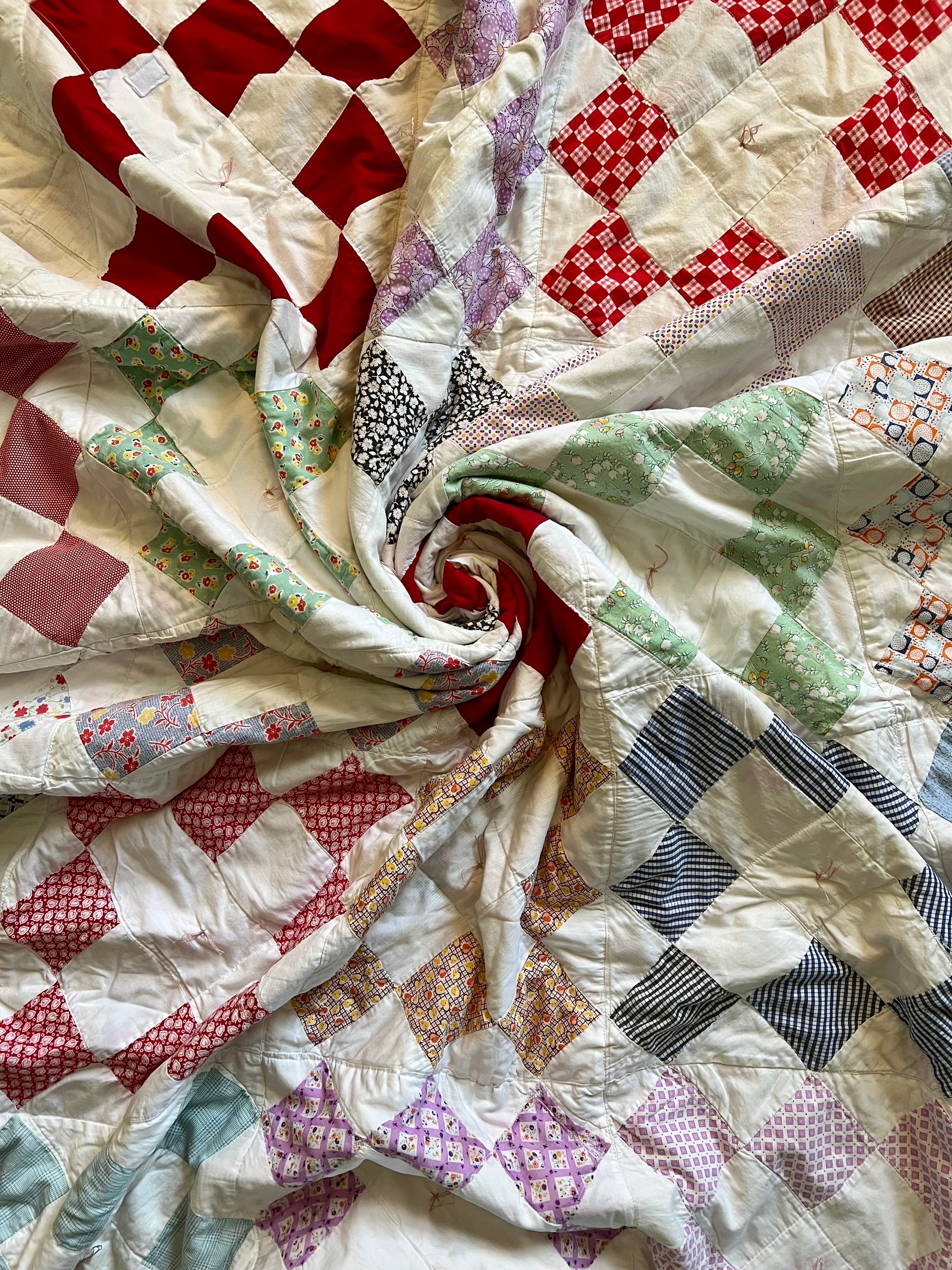 Vintage Diamond Square quilt. spiral aerial view. the middle is scrunched together to show texture