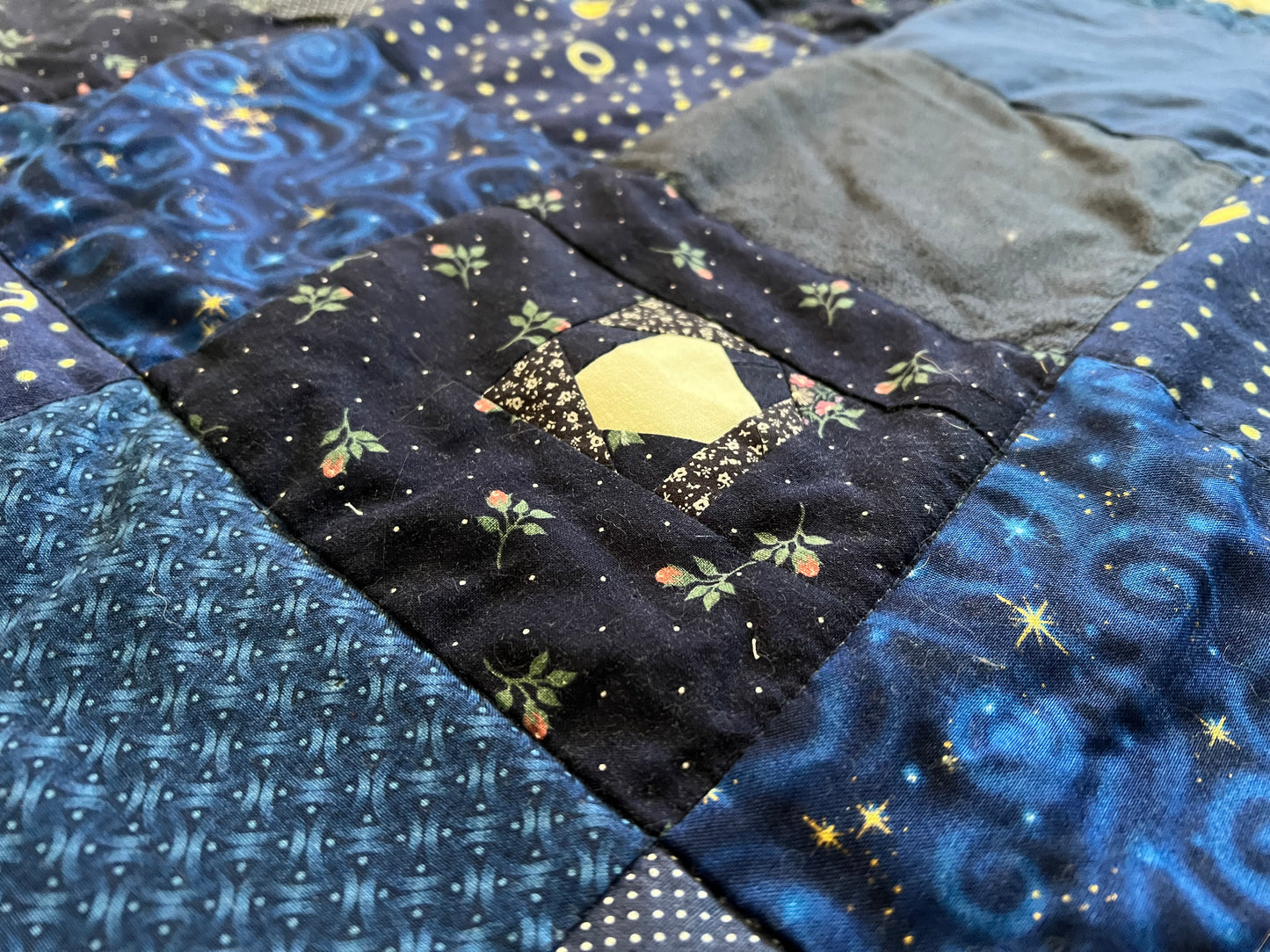 closeup of one of the scrappy stars within a patchwork square of the moon quilt