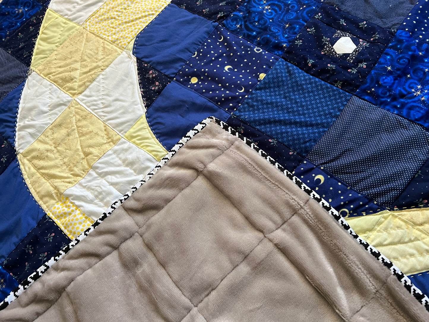 quilt, with a corner folded over the top, to show the fuzzy backing