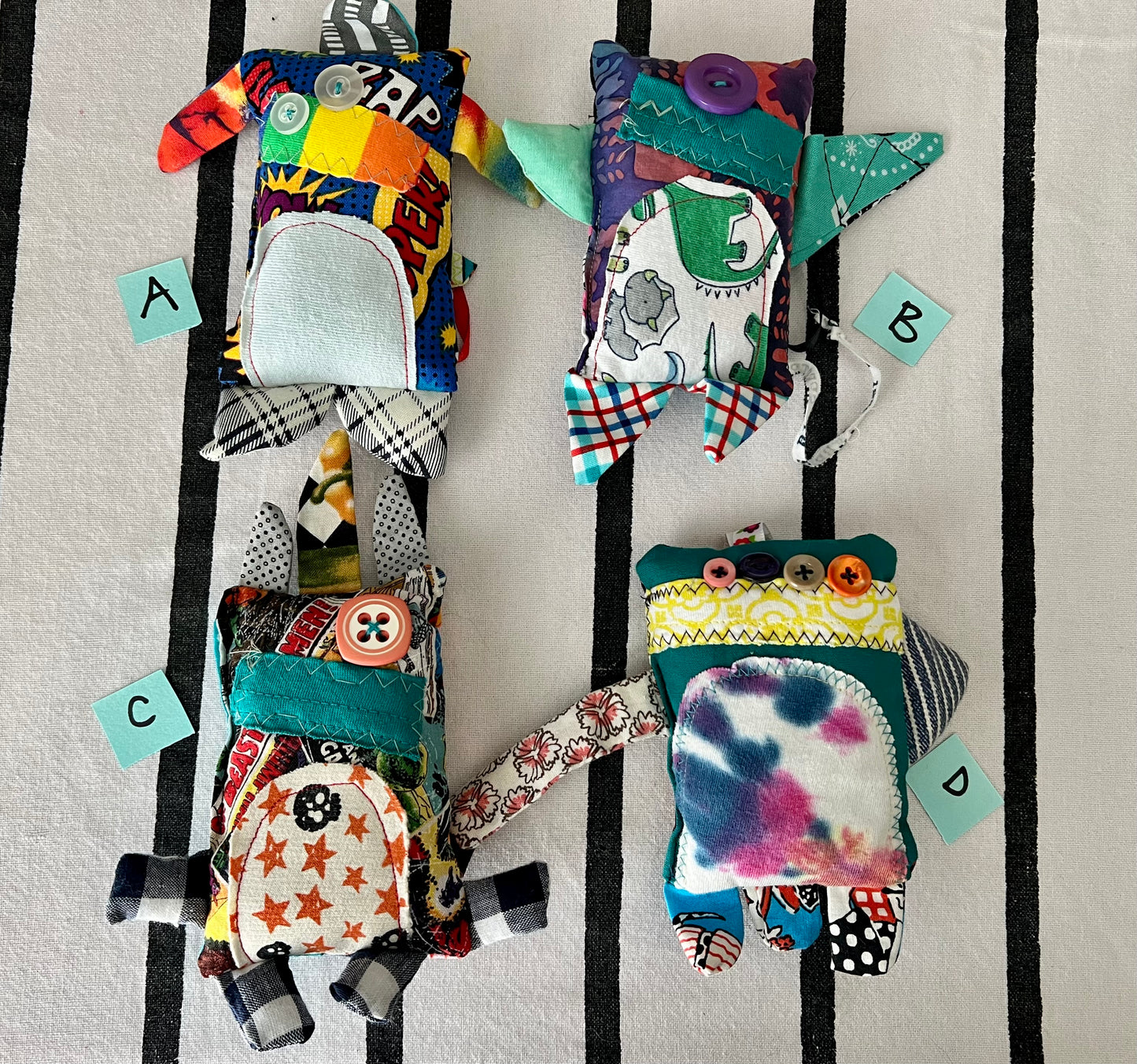 front view of mini monsters with letters A B C D next to each one.