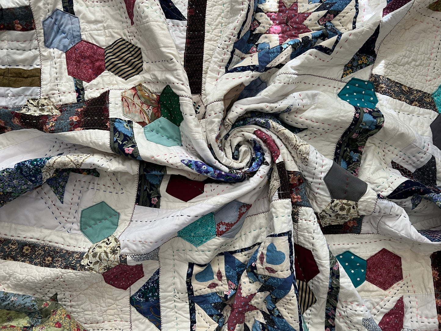 eight point stars, and scrappy hexagons quilt, swirled in center to show texture