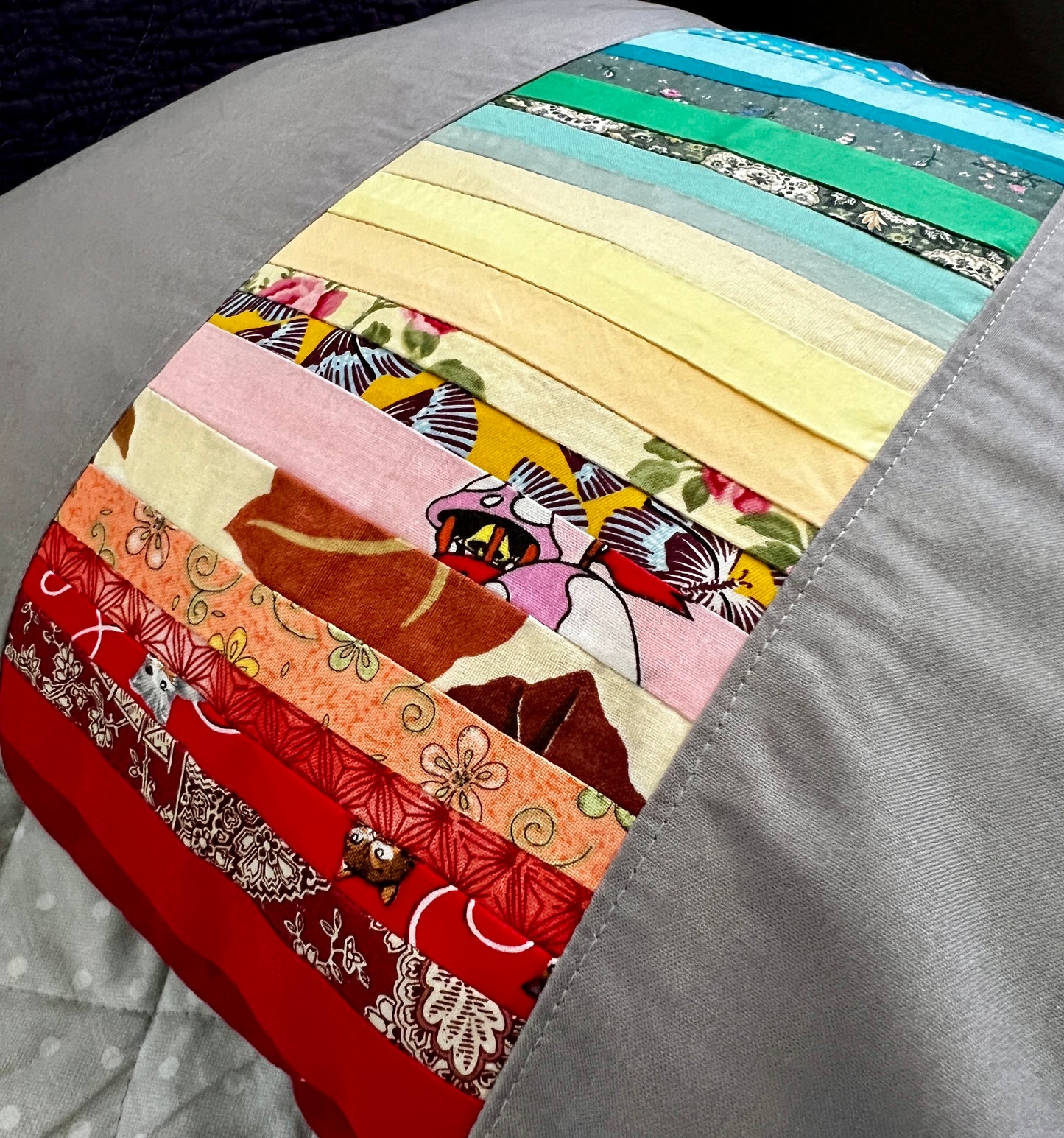 closeup side view of rainbow ombre scrap stripe pillow cover