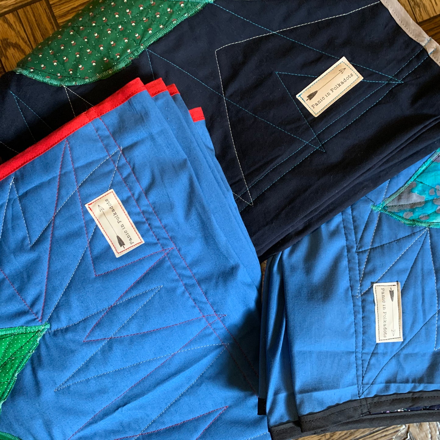 All three rose wall hangings, with a closeup of labels which read "Panic in Polkadots"