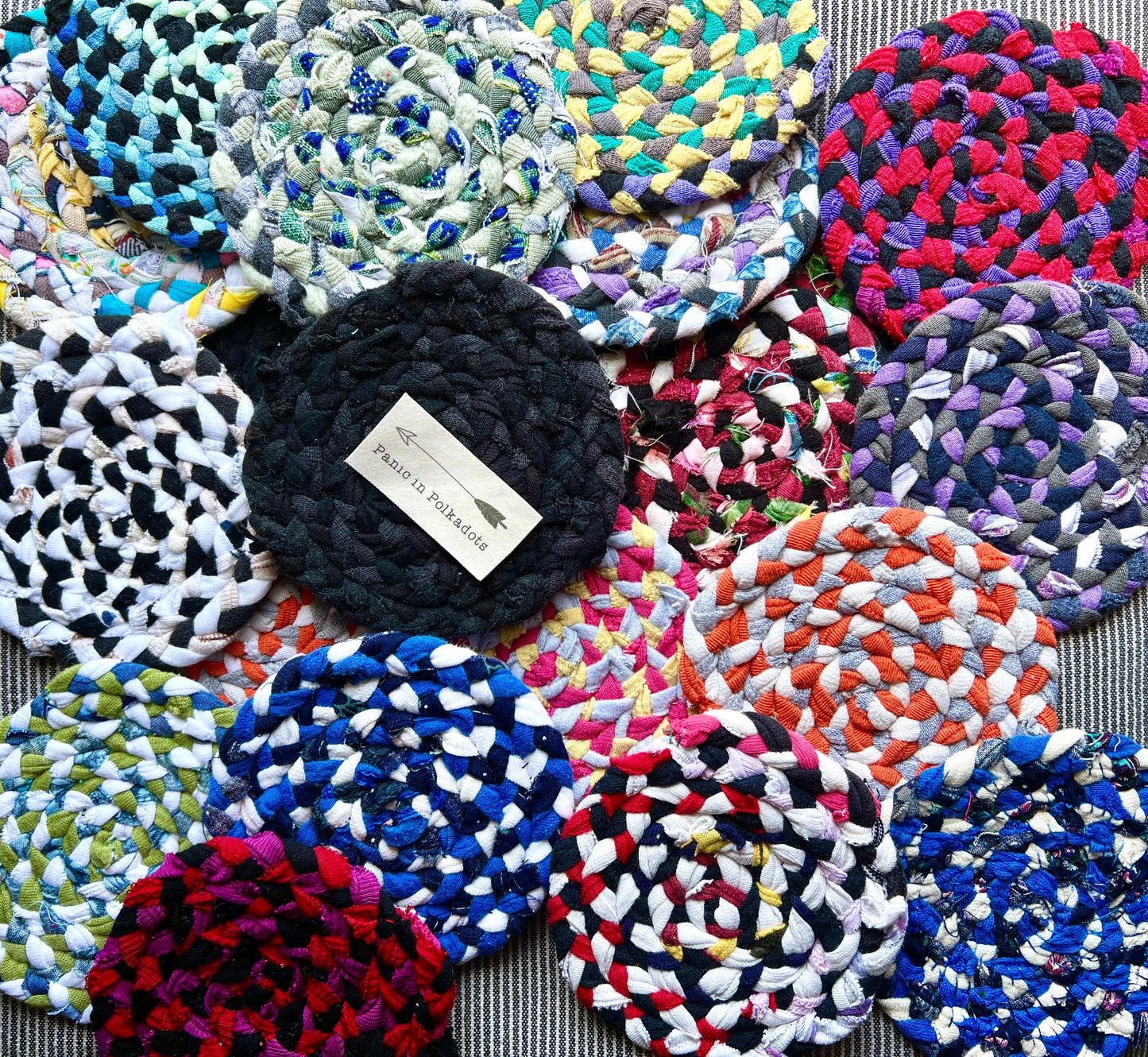 single coaster assortment, with a Panic in polkadots label on top of an all black coaster