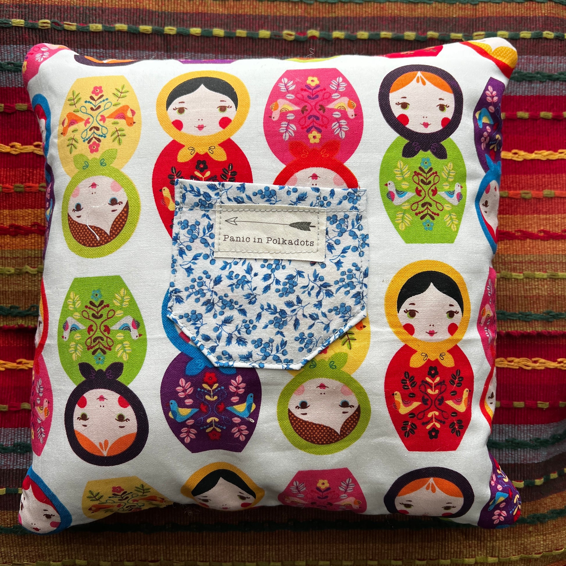 matryoshka little pillow back view with pocket,  lay flat against a colorful background