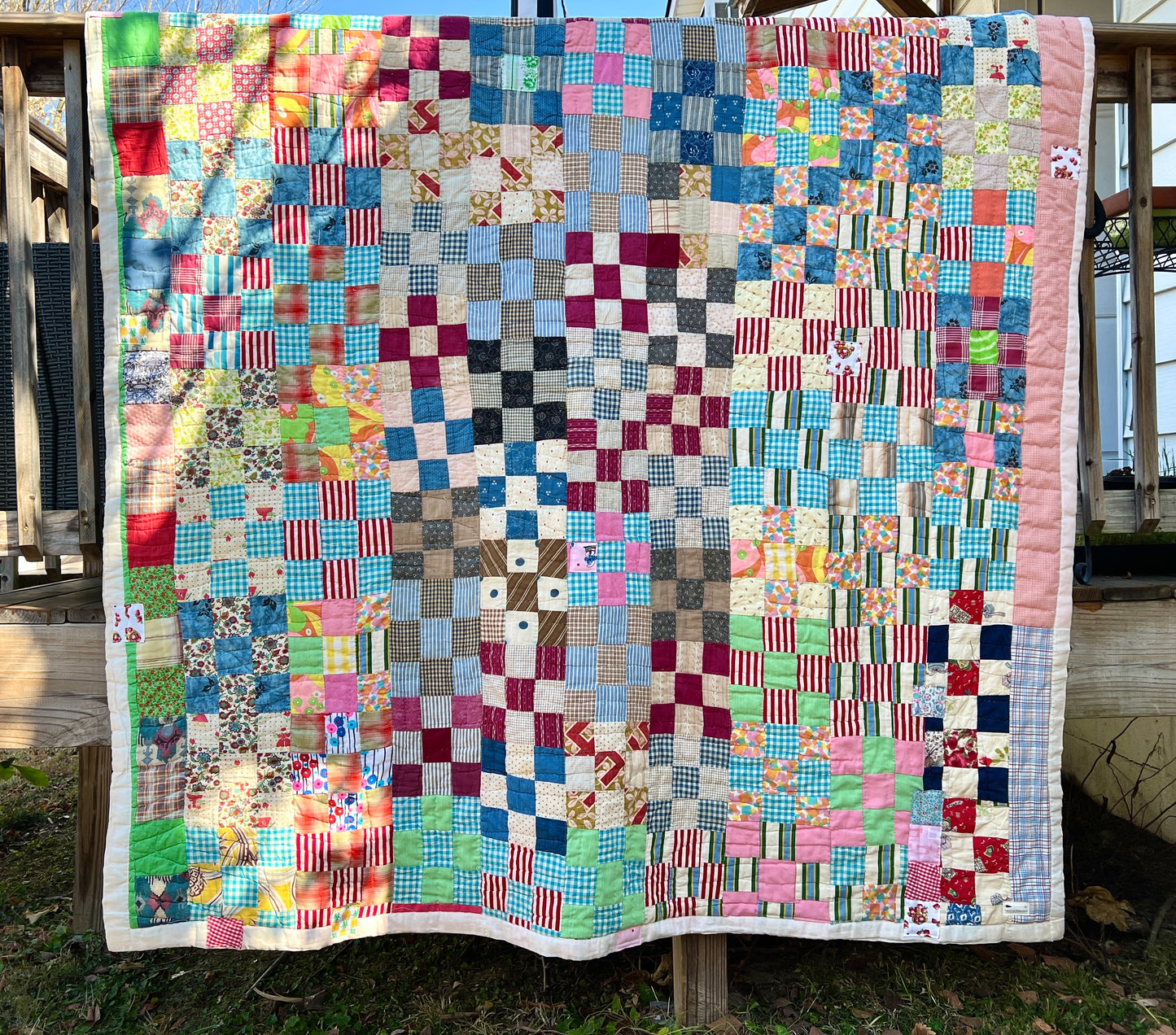 colorful 9 square quilt on fence, vintage quilt, reworked