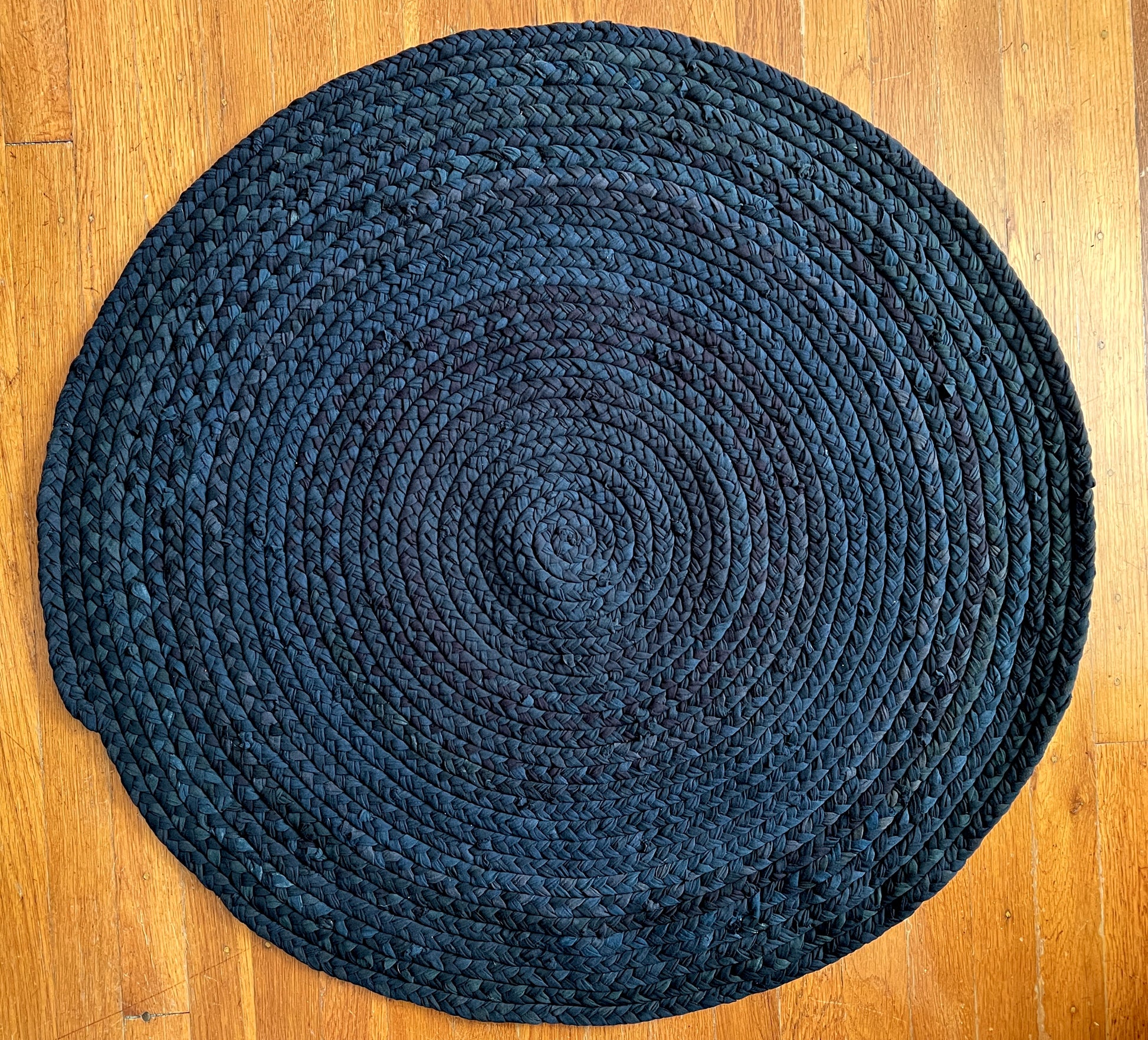 bird's eye view of the top of rug, on top of a wood floor