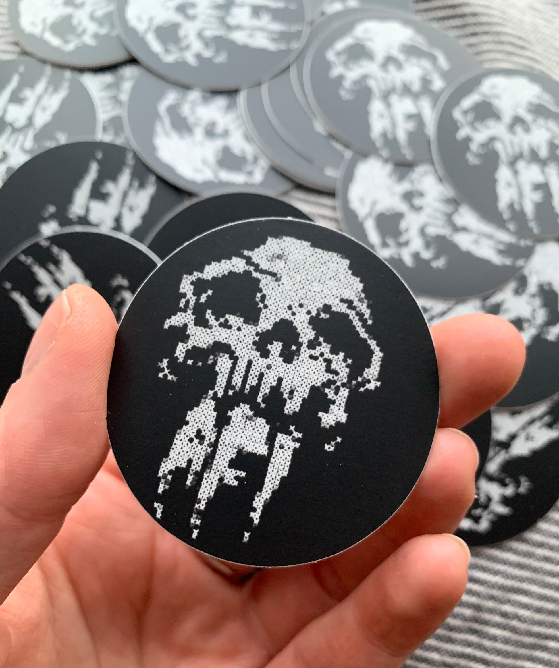 AFi skull design sticker, created from my embroidery, in a hand for scale