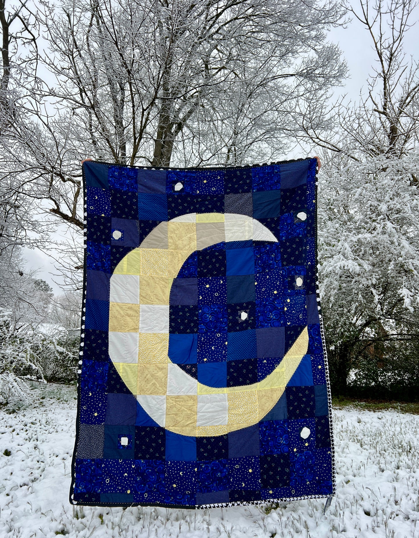A quilt with eight point stars and quilted hexies, outside scene in a freshly fallen snow