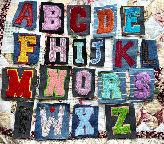 Alphabet letters made from fabric on a quilted background