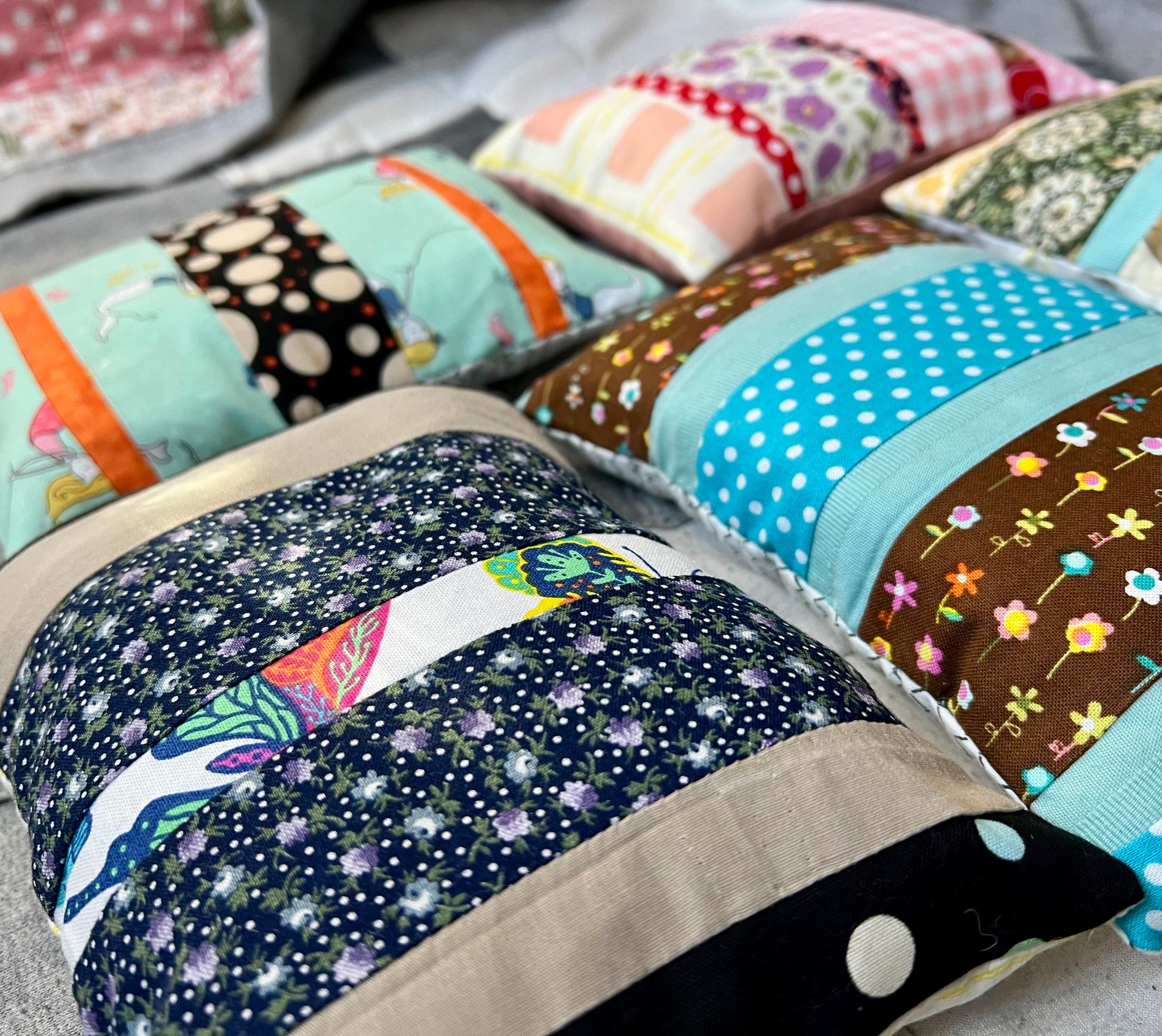 American Girl doll pillows, made from scrappy fabric strips, side angle view.