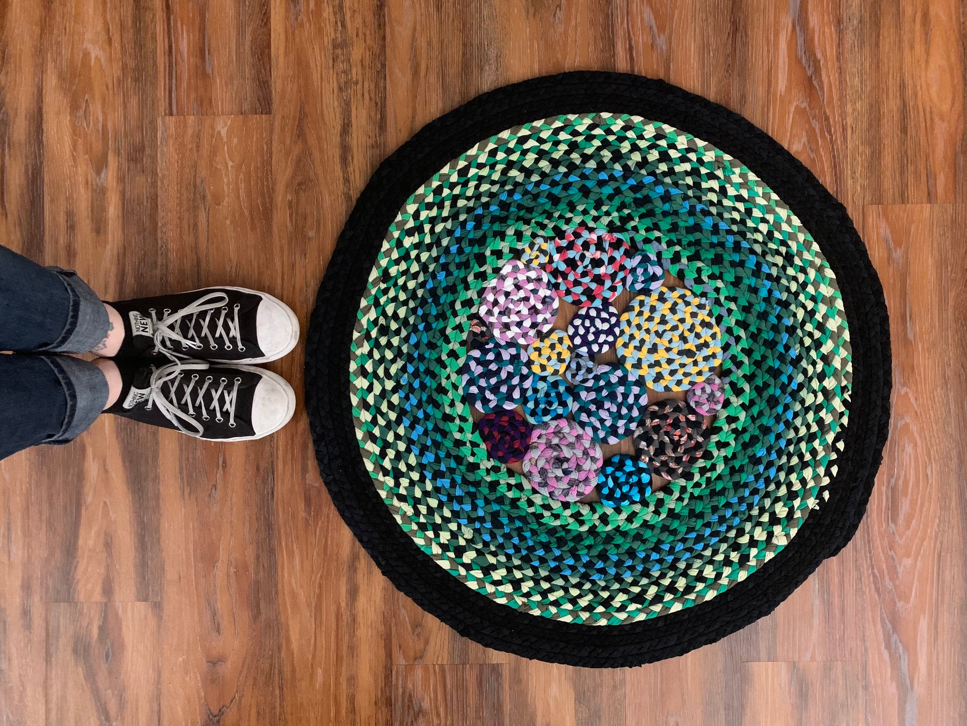 aerial view of green garden rug, with feet nearby wearing Nothing New shoes for scale