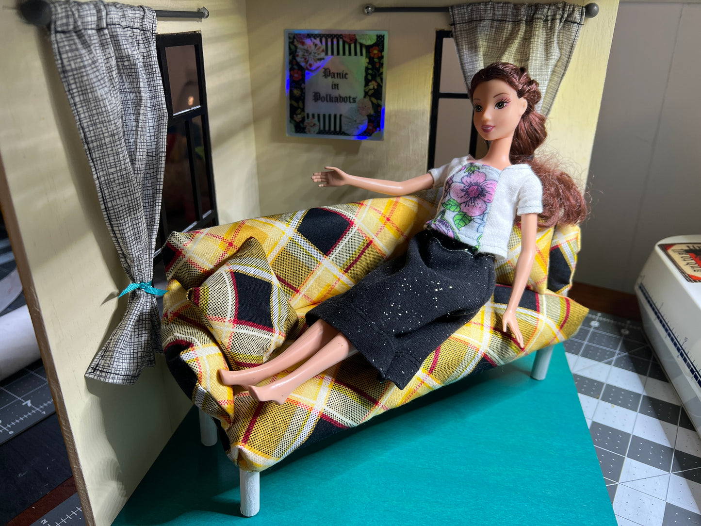 Barbie on couch yellow plaid, shown in a roombox for styling and scale 1:6