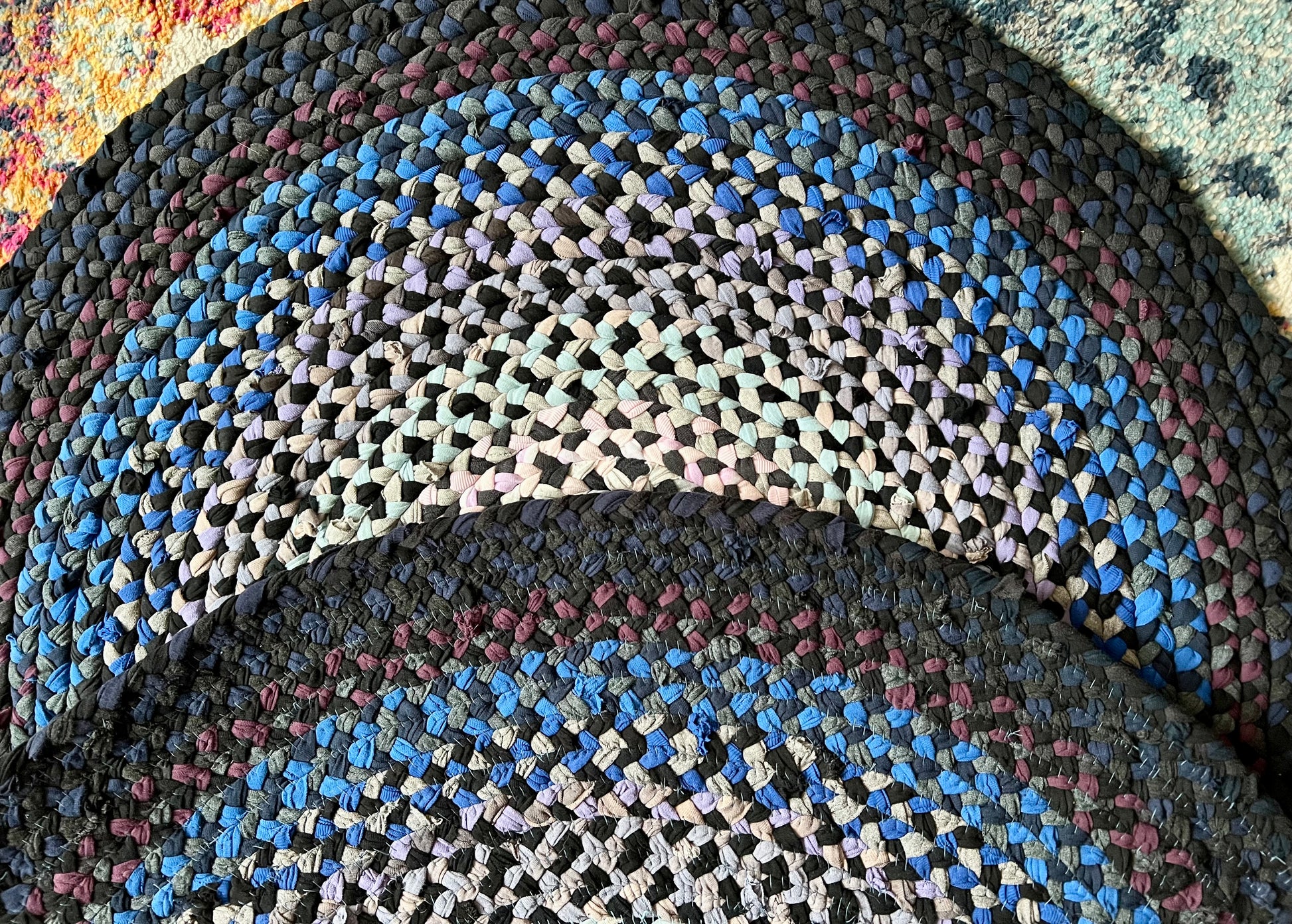 Multicolored braided rug with a circular pattern