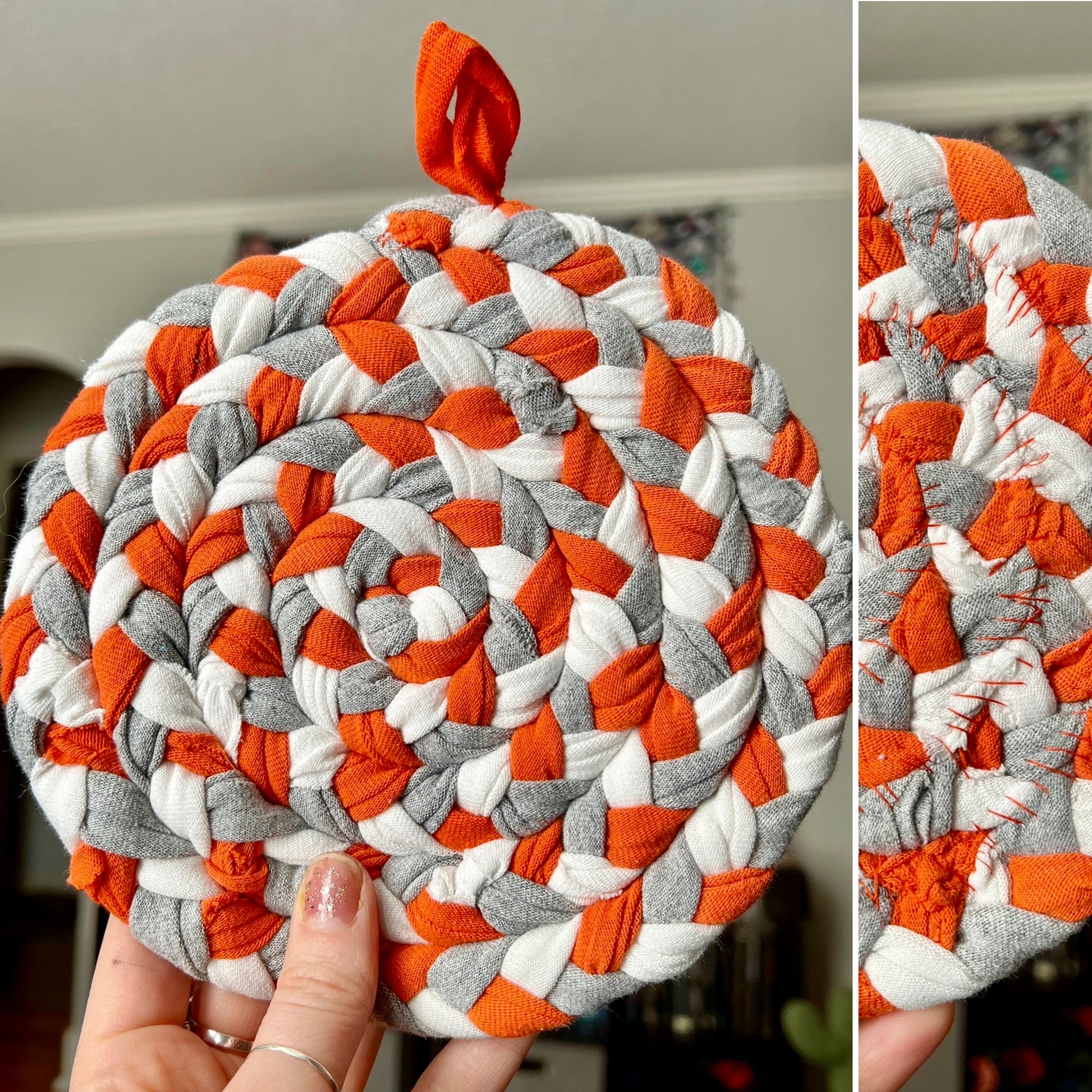 Round braided trivet with orange, gray, and white pattern held by a hand.