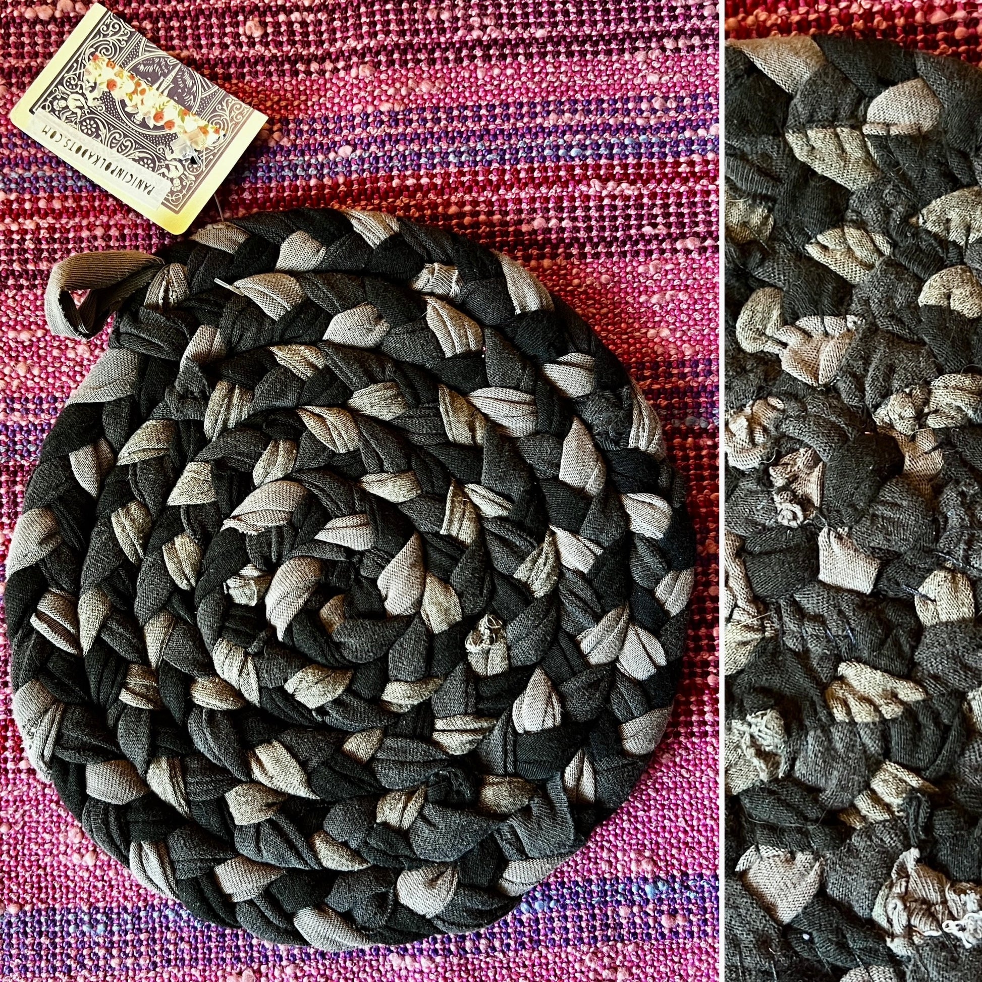 Coiled braided trivet on a pink and purple striped background