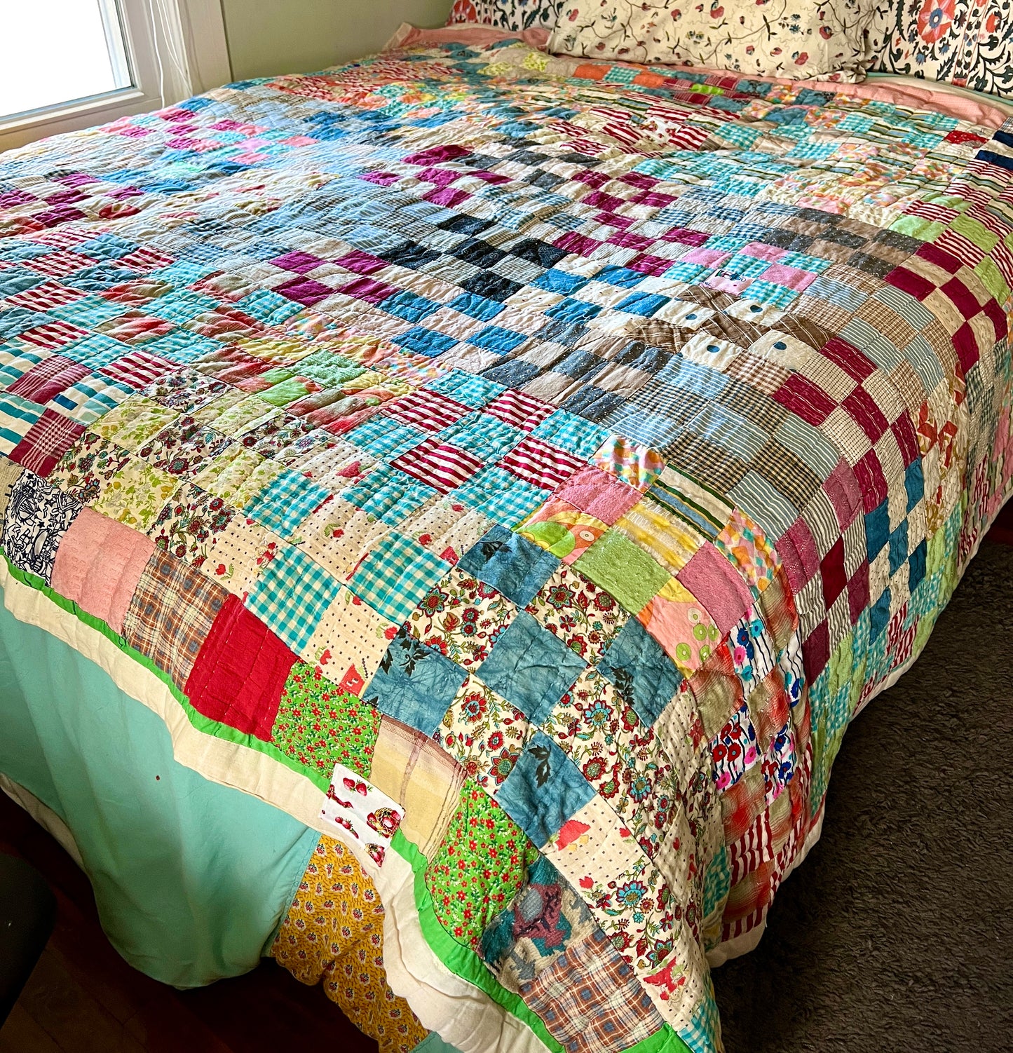 Colorful neon nine squares quilt on bed