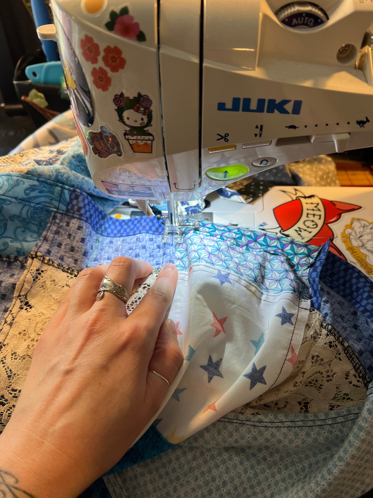 Person using a sewing machine with a colorful fabric in the background