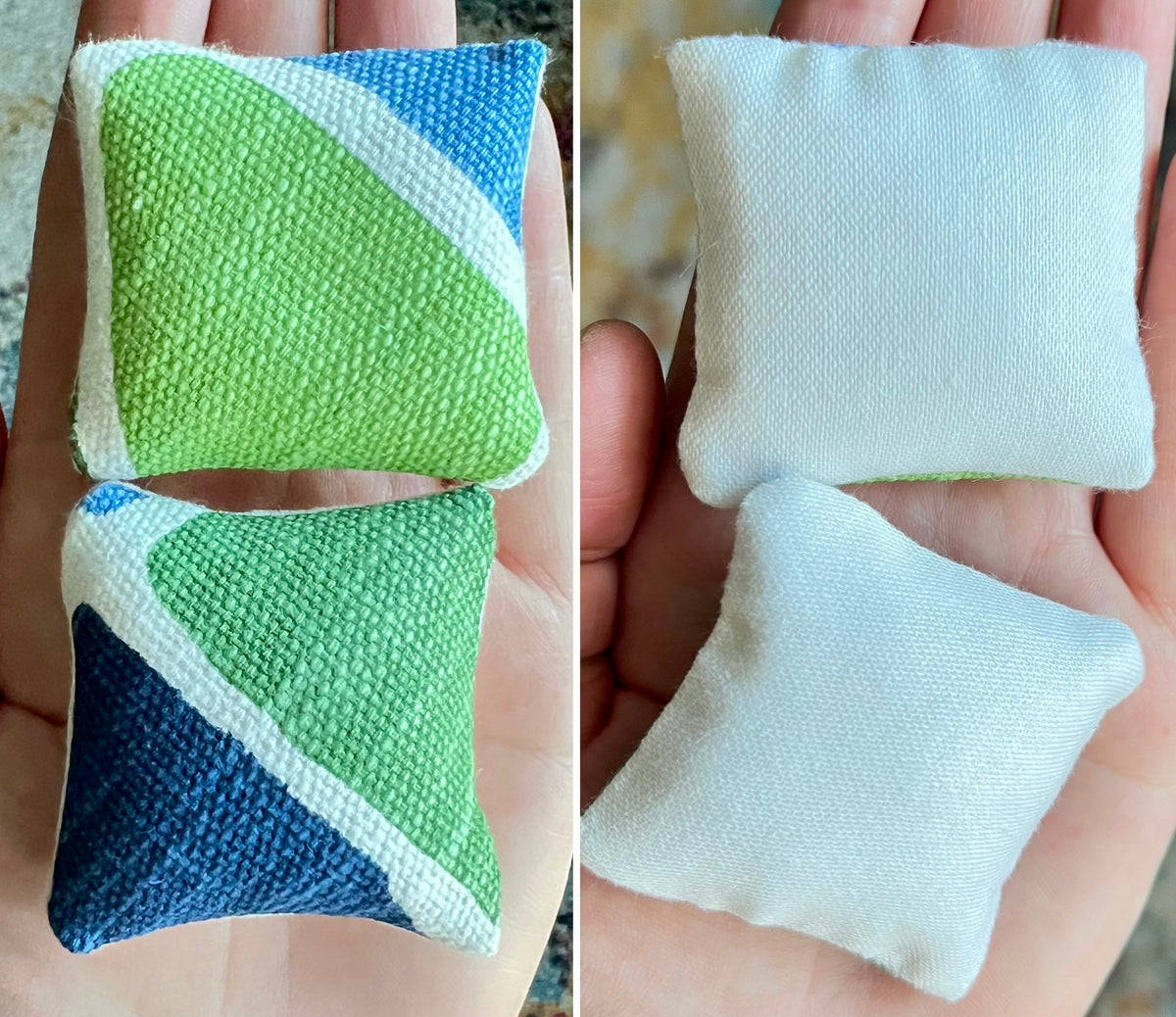 Two fabric doll pillows, front green and blue, the back white, held in hands.