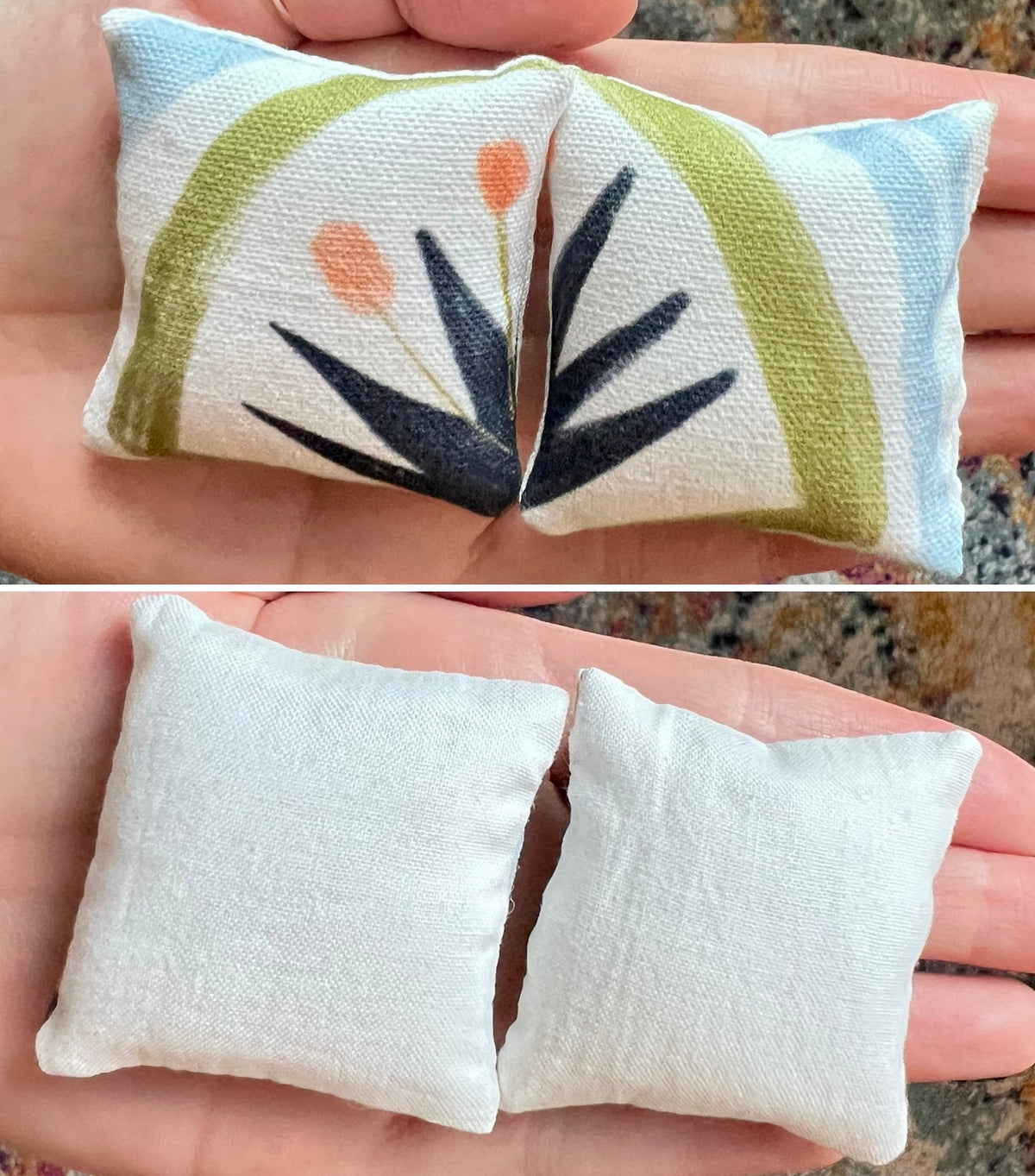 Two small fabric pillows, front with a floral agave leaf pattern and back plain white, held in hands against a natural background.