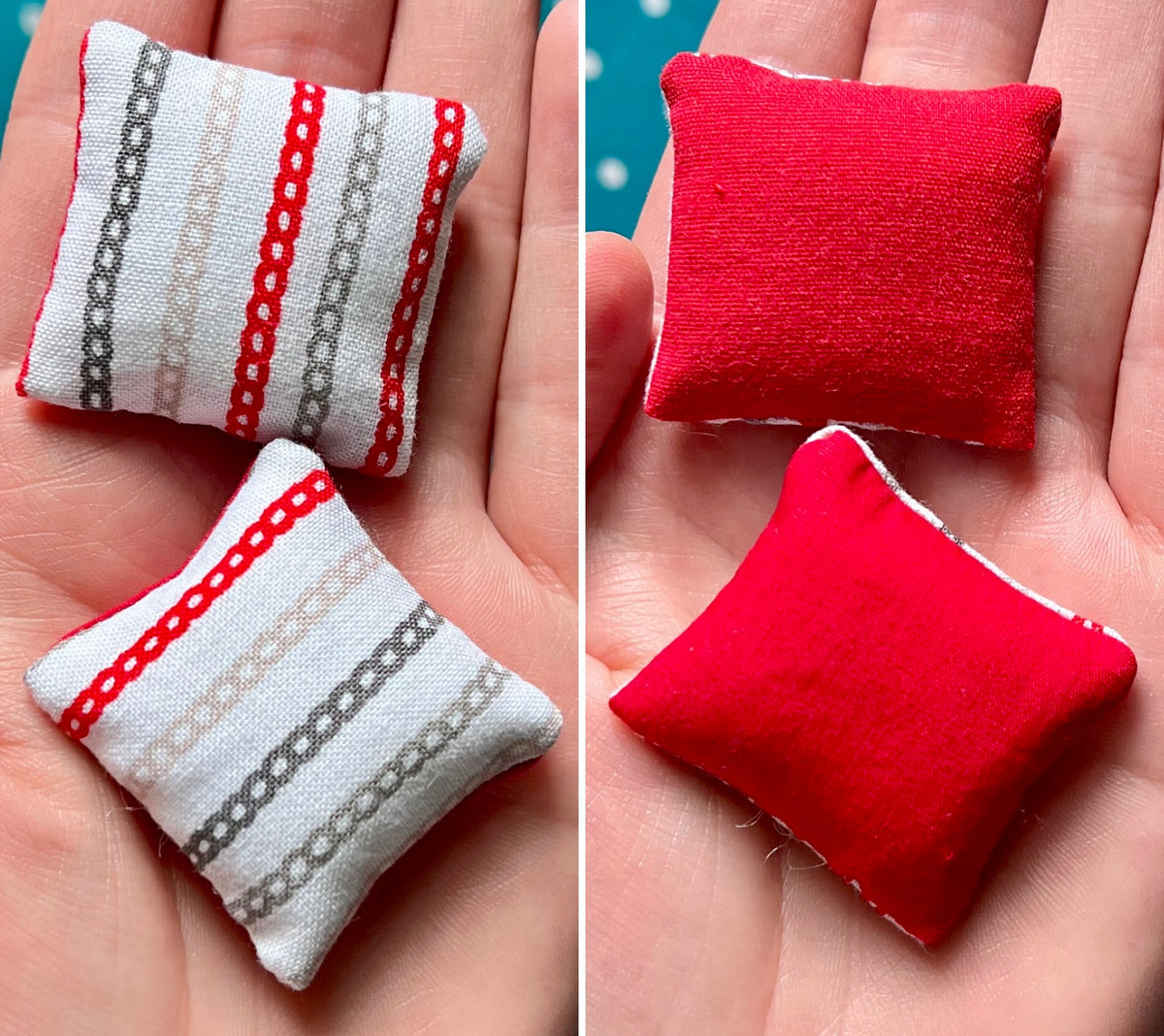 Two small fabric pillows, front striped and back solid red, held in a hand.