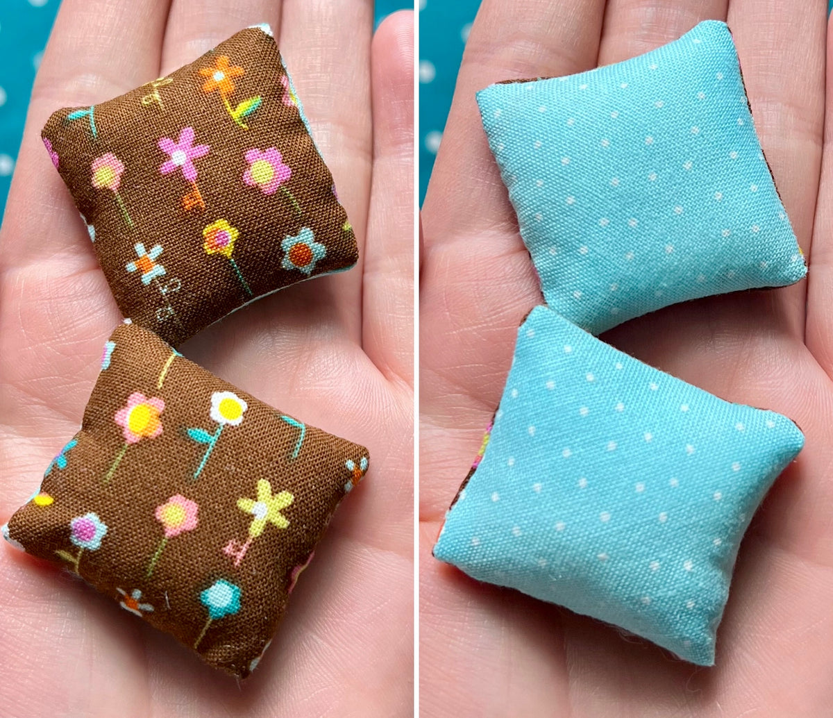 Two small fabric pillows, front is brown with floral patterns and back is blue with polka dots, held in hands.