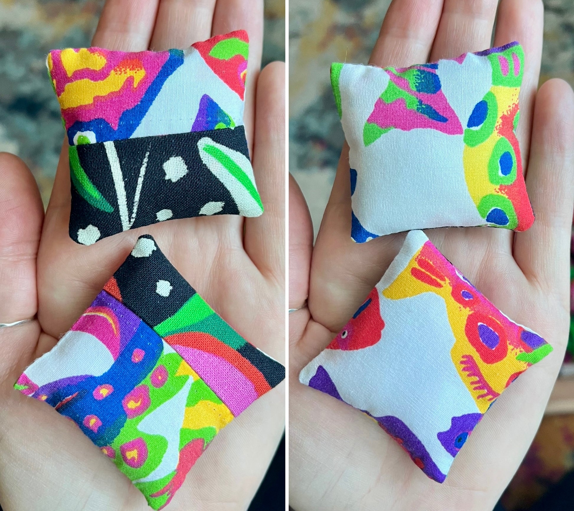 Colorful fabric pillows held in hands with a blurred background